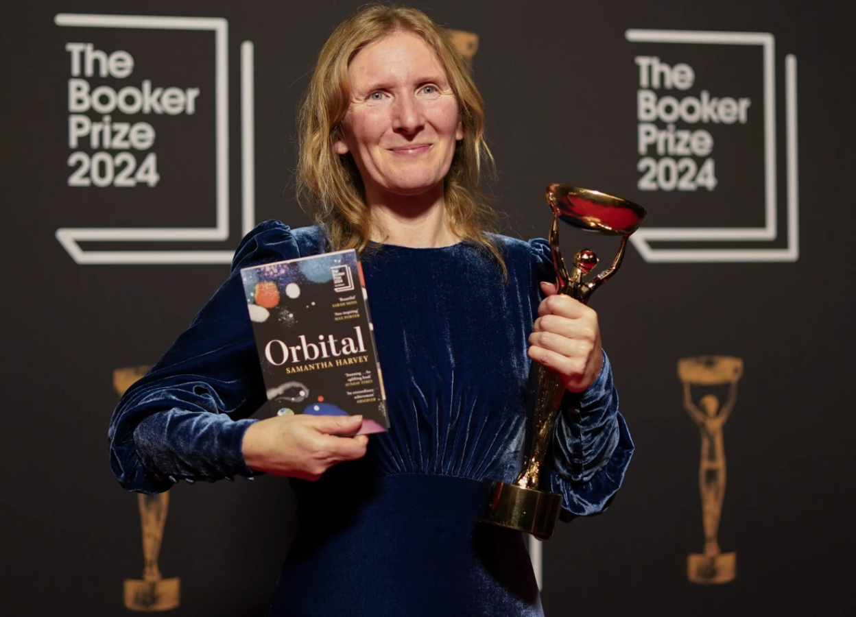 Samantha Harvey poses with the trophy and her book “Orbital” after winning the Booker Prize in London, Tuesday, Nov. 12, 2024.