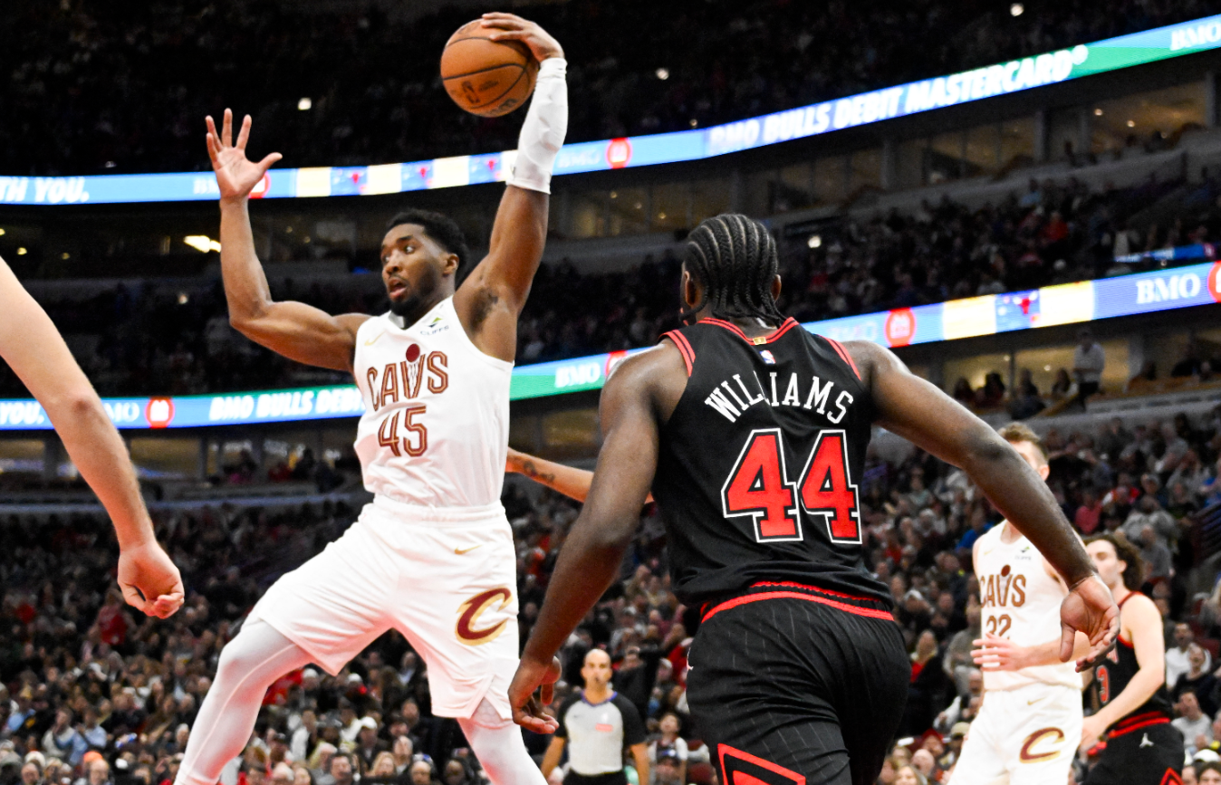 Cleveland Cavaliers guard Donovan Mitchell (45) grabs a rebound away from Chicago Bulls forward Patrick Williams (44) during the second half at United Center in Chicago, Illinois,  Nov. 11, 2024.