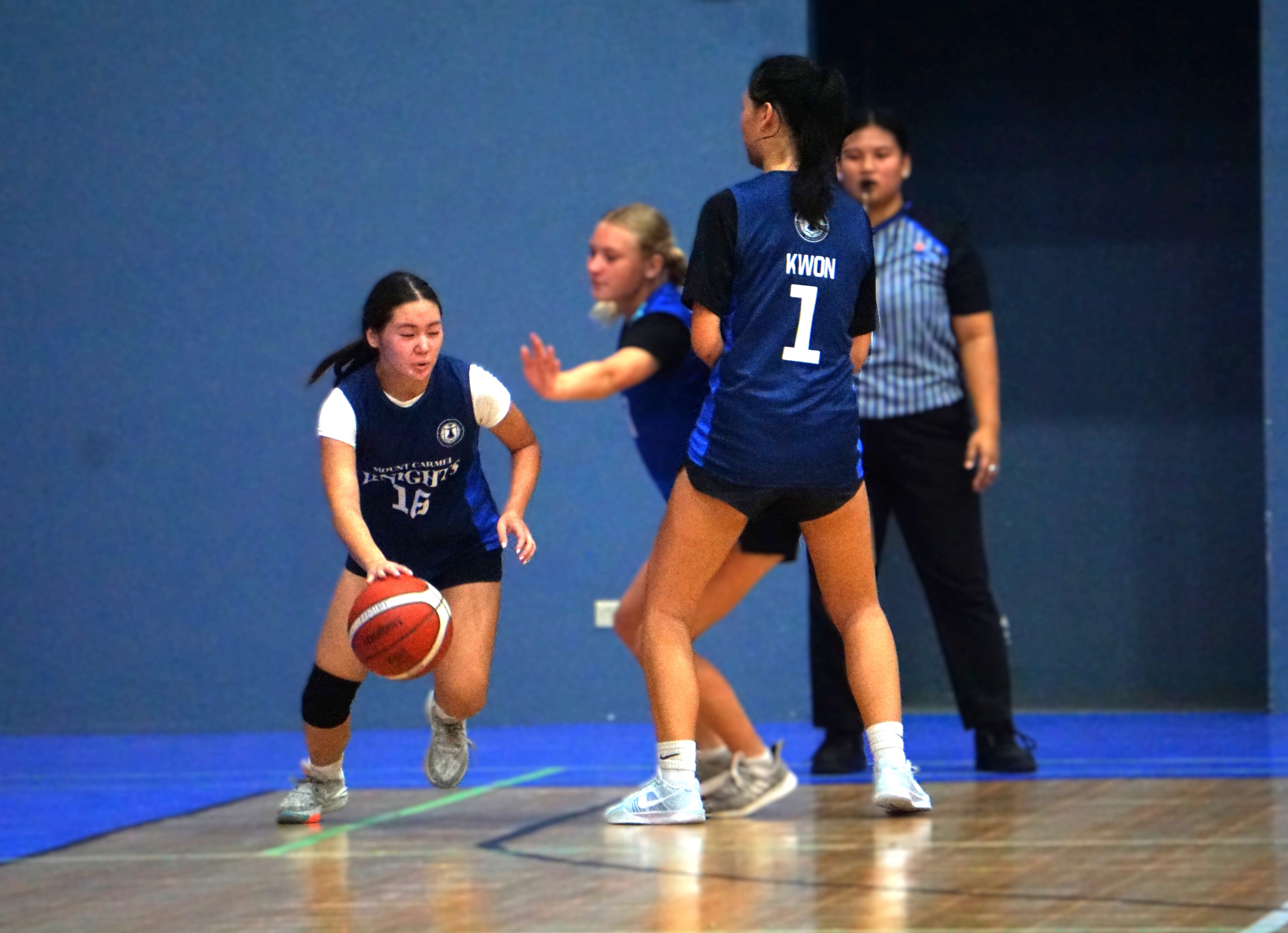 Mount Carmel School's Mya Pangelinan loses a defender off a screen from teammate Jieun Kwon during a girls high school division game of the PSS-NMIBF Interscholastic Basketball League at the Marianas High School gym.
