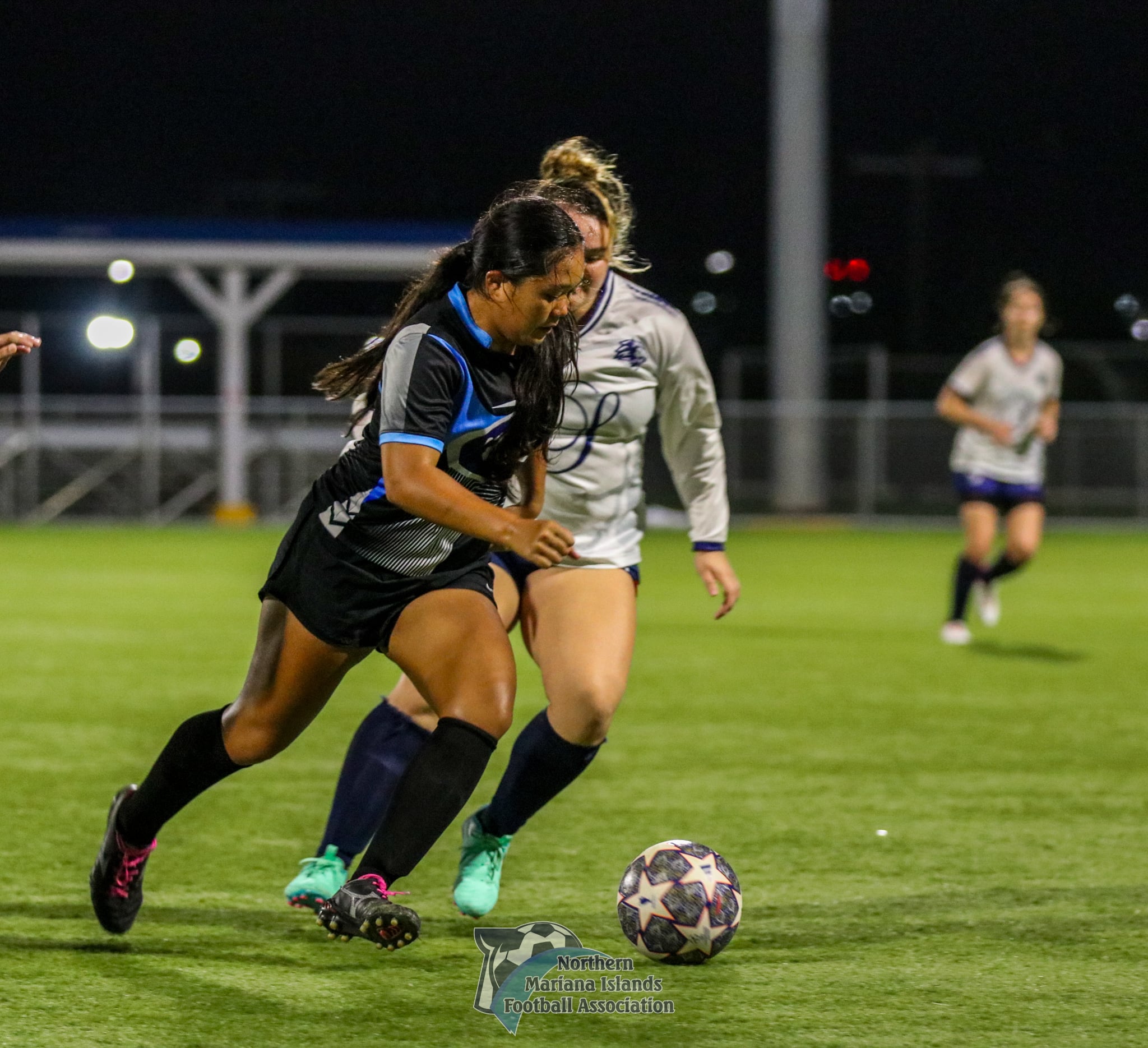 MPU Pink's Pia Ngewakl attempts to beat a defender during a Dove Women's League Fall 2024 game at the NMI Soccer Training Center in Koblerville. 