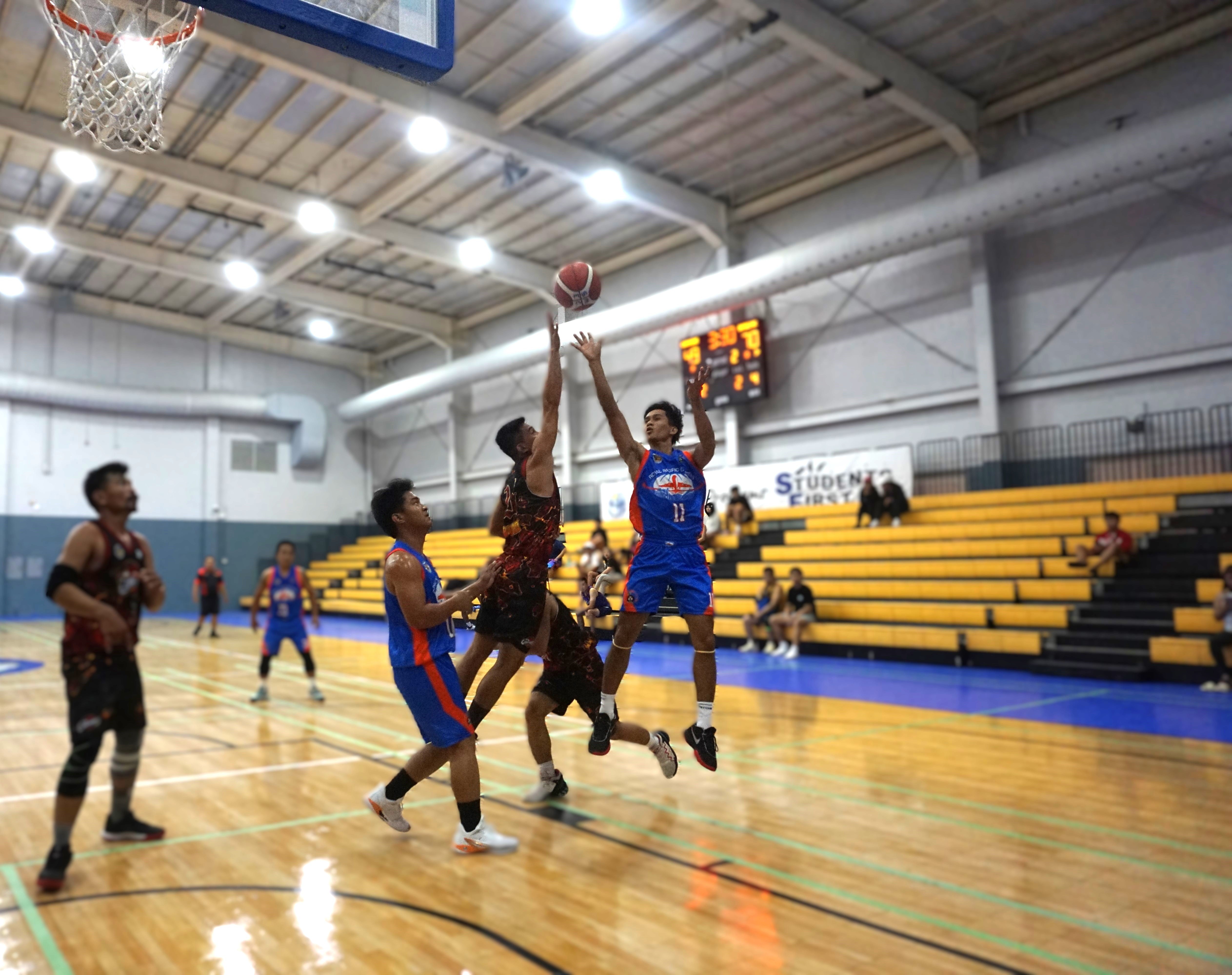 Royal Pacific/Islander Rent A Car’s Jeffrey Victoria attempts a floater over a defender during an open division game of the 2nd SMEC-SMLEG Basketball Tournament at the Ada gym on Sunday. 