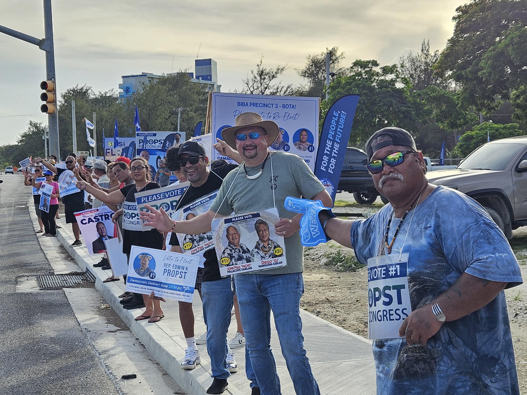 U.S delegate candidate Edwin Propst and supporters wave at motorists on Beach Road in Susupe across from Marianas High School on Sunday.