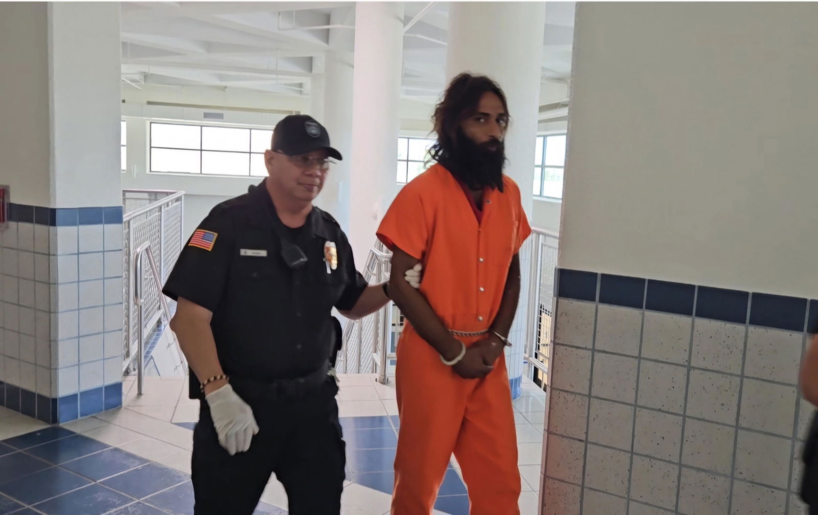 Omar Nawaz is escorted by a Corrections officer at the courthouse on Monday morning.