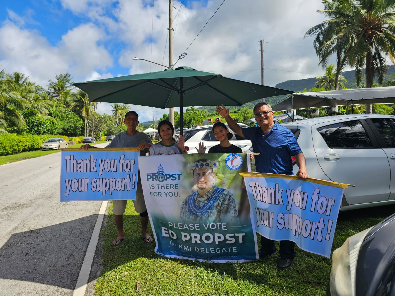 Sen. Paul A. Manglona, who is seeking re-election, joins his supporters as they hold a campaign banner for U.S. delegate candidate Edwin Propst in  Sinapalo, Rota.