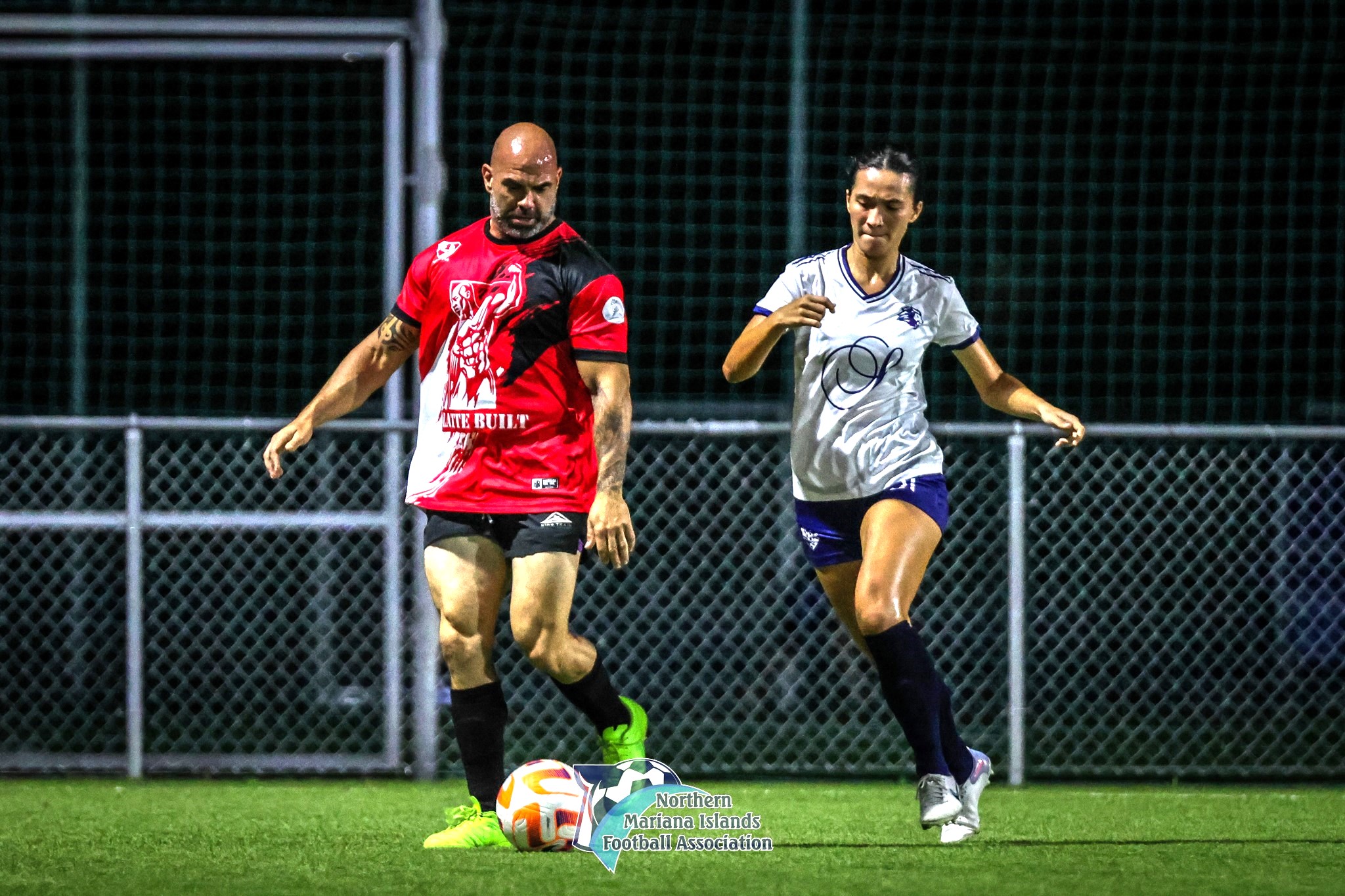 Paire FC's Derek Cutting secures the possession as Shirley's FC's Bernadette Horey closes in during a game of the Marianas Soccer League 2 Fall 2024 tournament at the NMI Soccer Training Center on Friday last week.