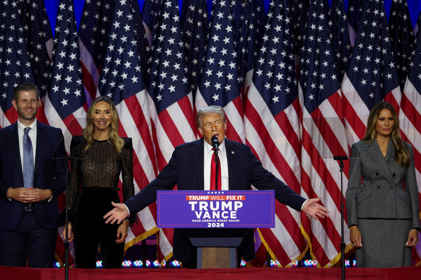 President-elect Donald Trump takes the stage with his wife Melania, his son Eric, and his daughter-in-law Lara, following early results from the 2024 presidential election at Palm Beach County Convention Center, in West Palm Beach, Florida, Nov. 6, 2024.