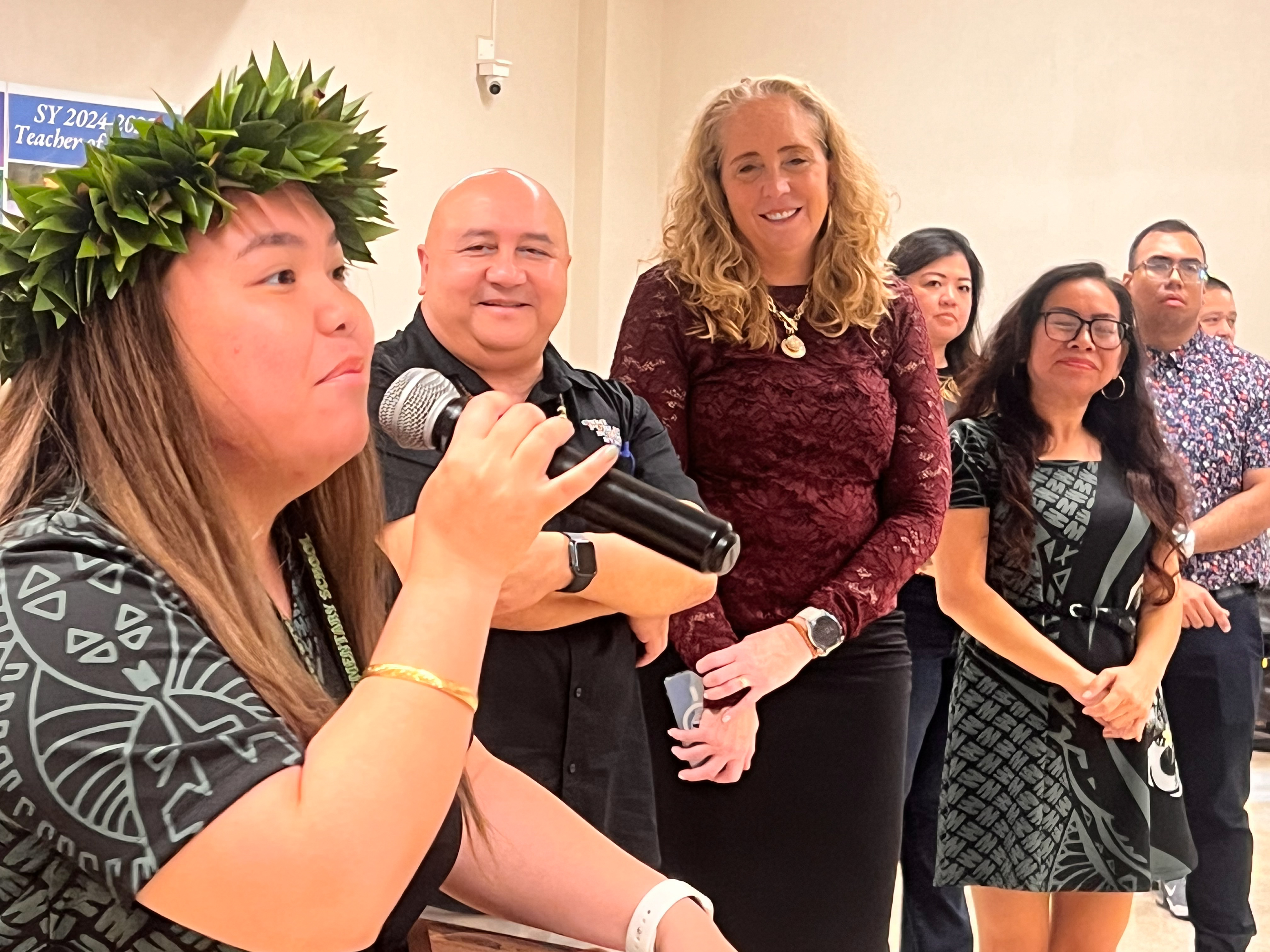 Koblerville Elementary School Counselor  Yvonnalyn Leonie S. Taimanao delivers her impromptu remarks after she was named the 2025 Public School System Counselor of the Year. Also in photo: Commissioner of Education Dr. Lawrence F. Camacho, CCSSO Chief Executive Officer Dr. Carissa Moffat Miller, KES Principal Naomi Nishimura, Federal Programs Officer Jacqueline Che, and Acting PSS Finance Director Jonathan Aguon.