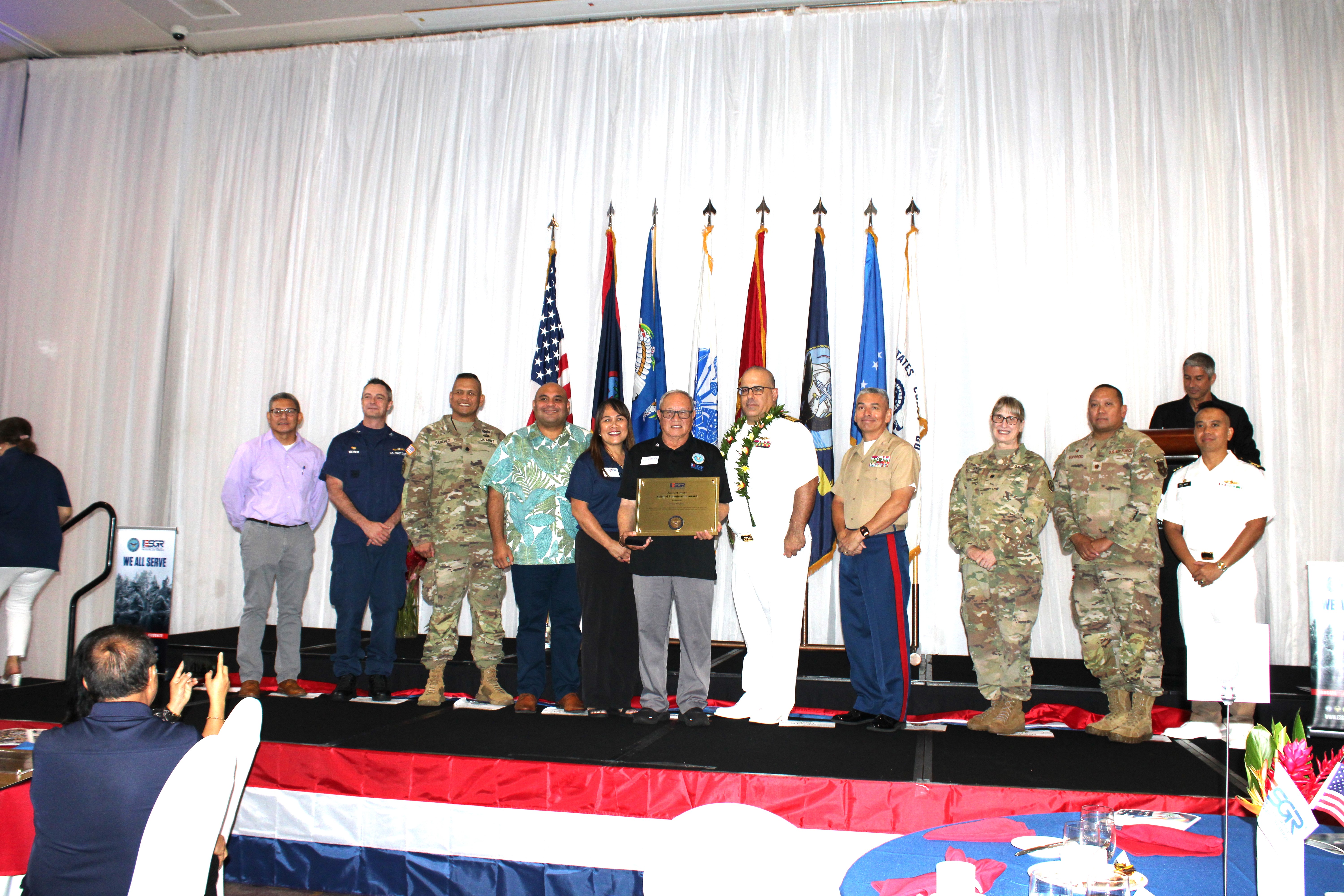 Guam’s first James M. Roche Spirit of Volunteerism National Award was presented to Retired U.S. Army Major General Benny M. Paulino, GU-CNMI Vice Chair, for his outstanding service to ESGR and the Department of Defense. From left: Lieutenant Colonel Victor Balajadia, Director of Staff Guam Air National Guard; Captain Robert Kistner, U.S. Coast Guard; Lieutenant Colonel Romeo Sanchez, 1st-294th Infantry Battalion, Guam Army National Guard: Acting Governor Joshua Tenorio; CathyAnn C. Gogue, GU-CNMI State Chair; Retired U.S. Army Major General Benny M. Paulino, GU-CNMI Vice Chair, recipient of the James M. Roche National Award; U.S. Navy Captain Craig S. Der Ananian, Navy Readiness and Mobilization Command, San Diego; Colonel Ernest Govea, Commanding Officer, Marine Corps Base Camp Blaz, U.S. Marine Corp.; Lieutenant Colonel Penny Sima, U.S. Army Reserve; Major Benjamin Guerrero, U.S. Air Force Reserve; and Lieutenant Commander Brian Matic, U.S. Navy Reserve.