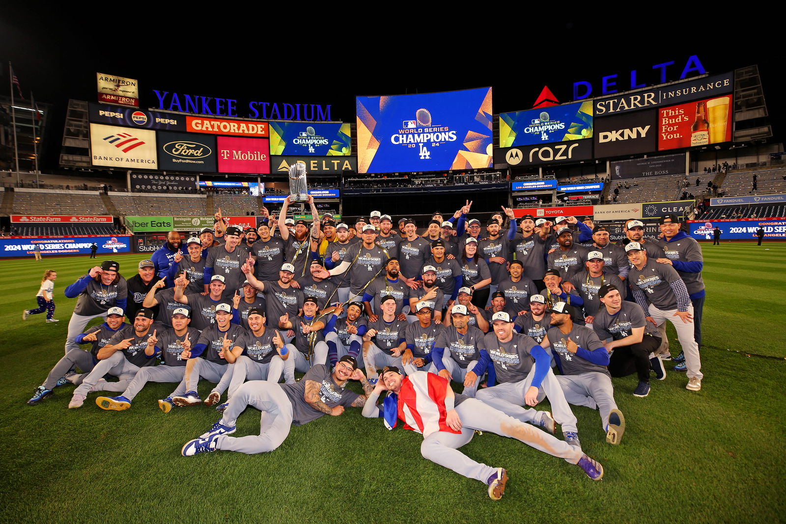 The Los Angeles Dodgers pose for a picture with the Commissioner’s Trophy after beating the New York Yankees in game four to win the 2024 MLB World Series at Yankee Stadium in New York, Oct. 31, 2024.