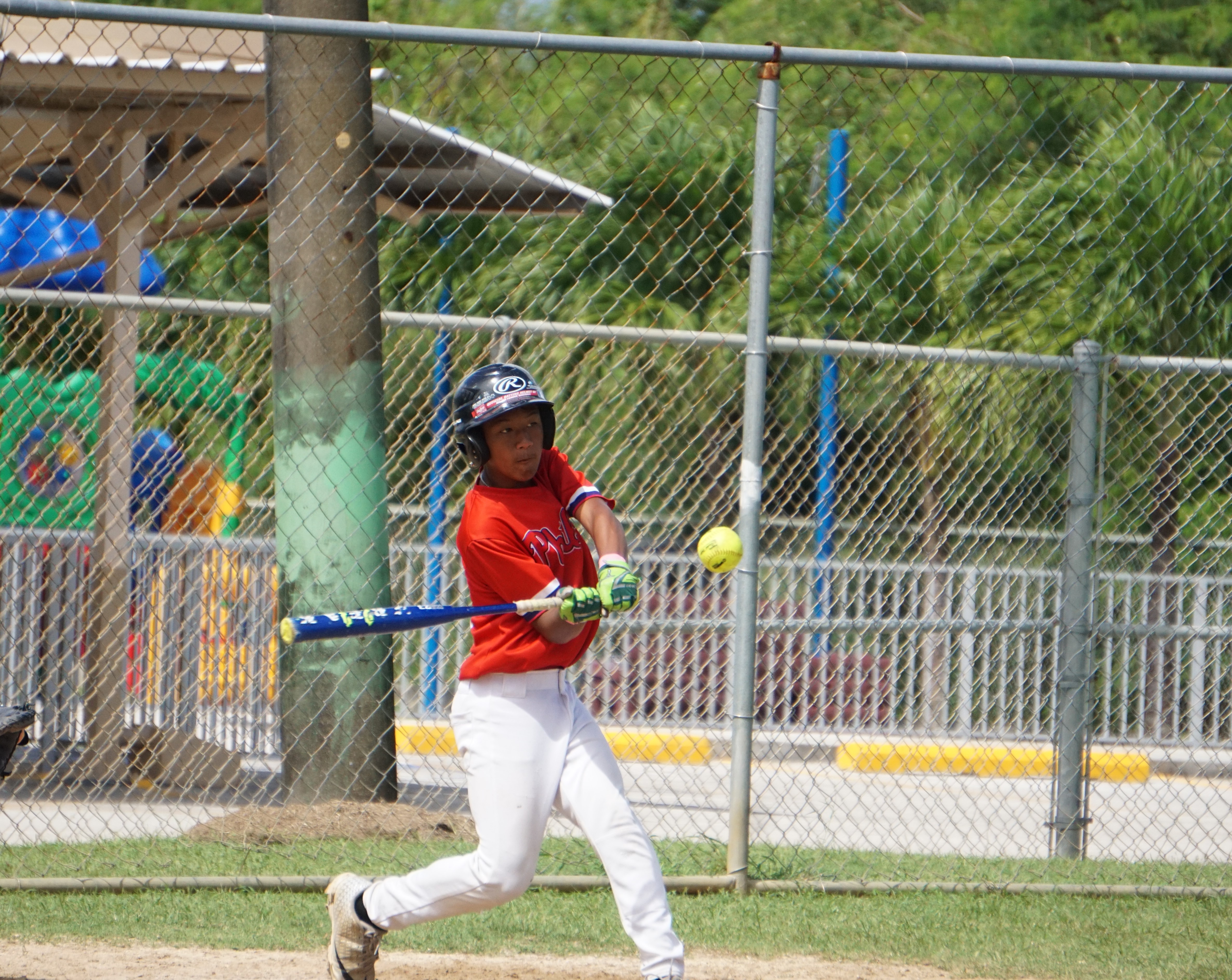 Hopwood Middle School's Caleb Cabrera connects a single during a boys middle school division game of the PSS-SBL Interscholastic Fastpitch Softball League SY24-25 at the Dandan softball field.