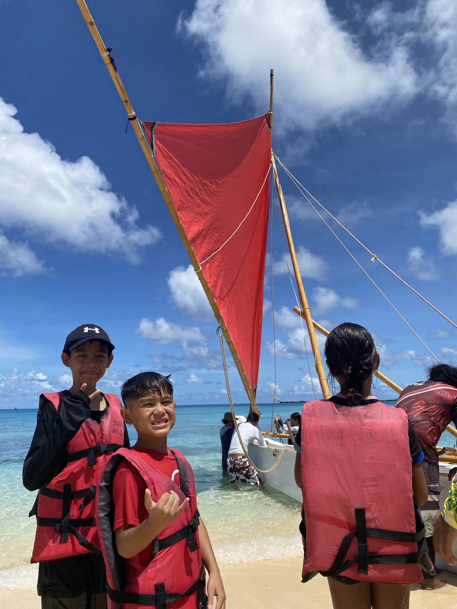 In 2019, 2021, and 2022, 500 Sails collaborated with 4-H Club’s Camp Maga’lahi to provide sailing experiences for their campers. Here, two island residents pose for the camera before riding the canoe Richard Seman in 2022. 