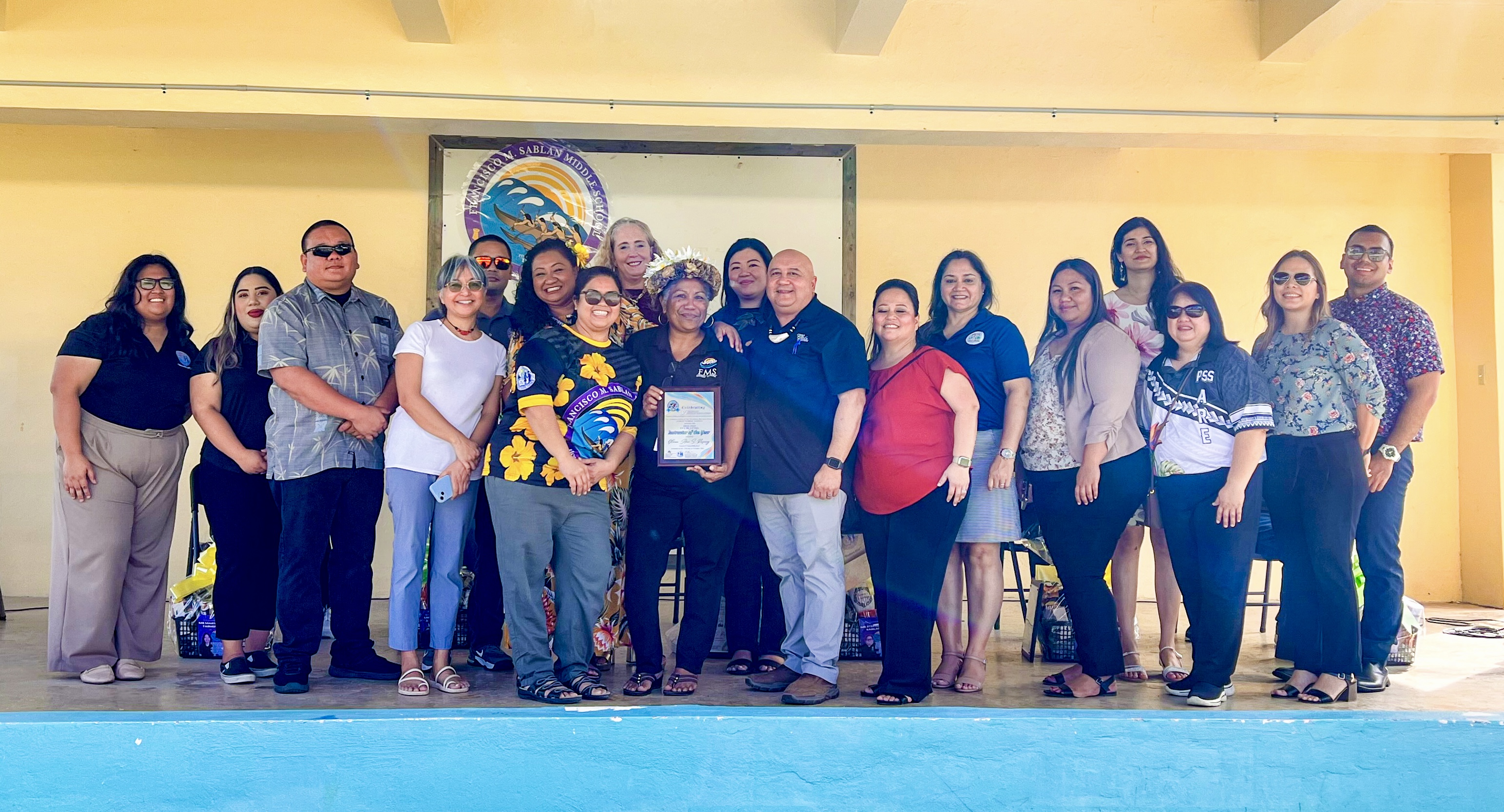 025 Instructor of the Year Gloria Ann S. Rasiang of Francisco M. Sablan Middle School with her FMS family and education and government leaders, led by Commissioner of Education Dr. Lawrence F. Camacho, CCSSO Chief Executive Officer Dr. Carissa Moffat Miller, and Gov. Arnold I. Palacios.