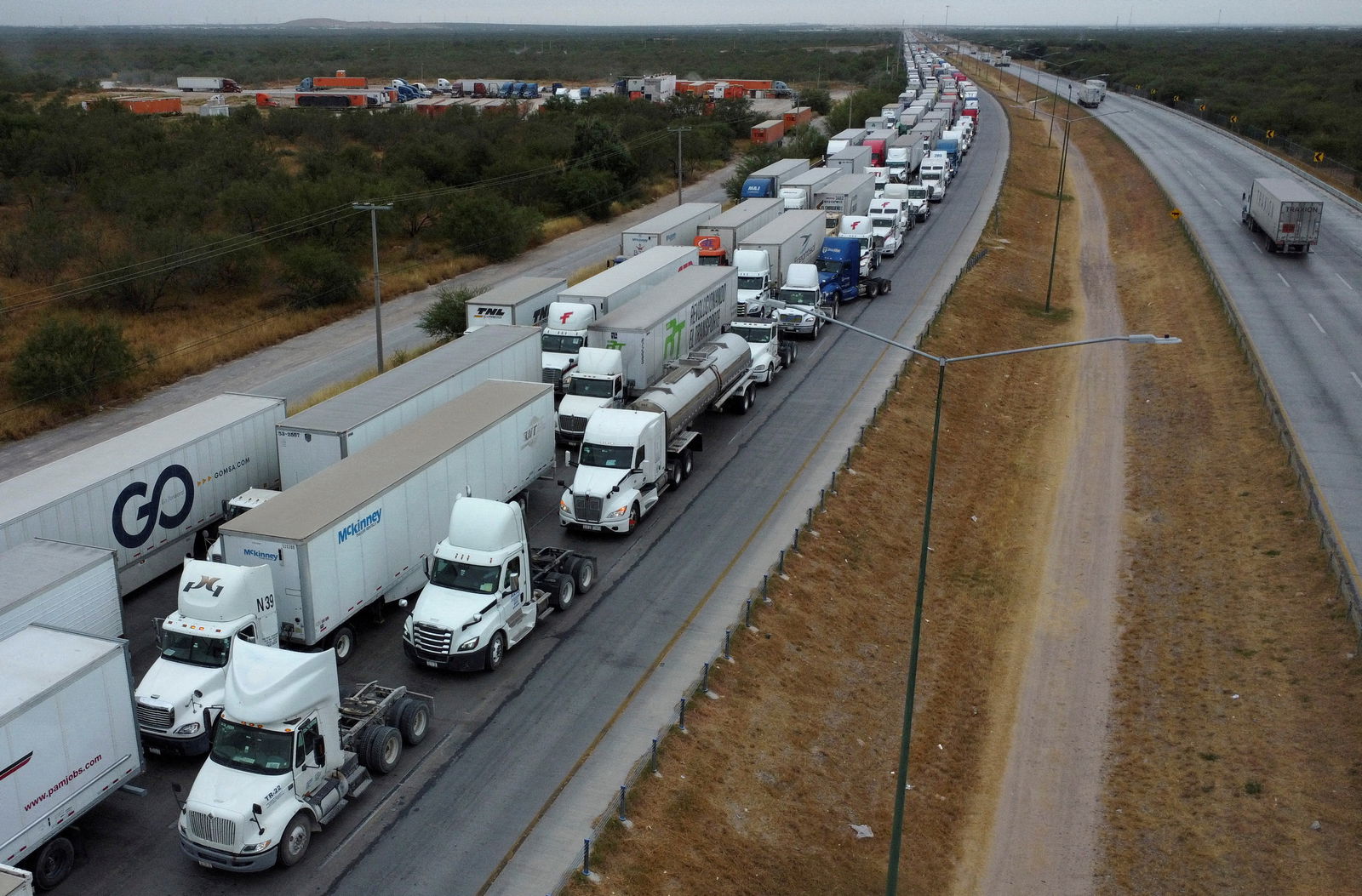 A drone picture shows trucks waiting in line to cross into the United States near the border customs control at the World Trade Bridge, in Nuevo Laredo, Mexico, Nov. 26, 2024.