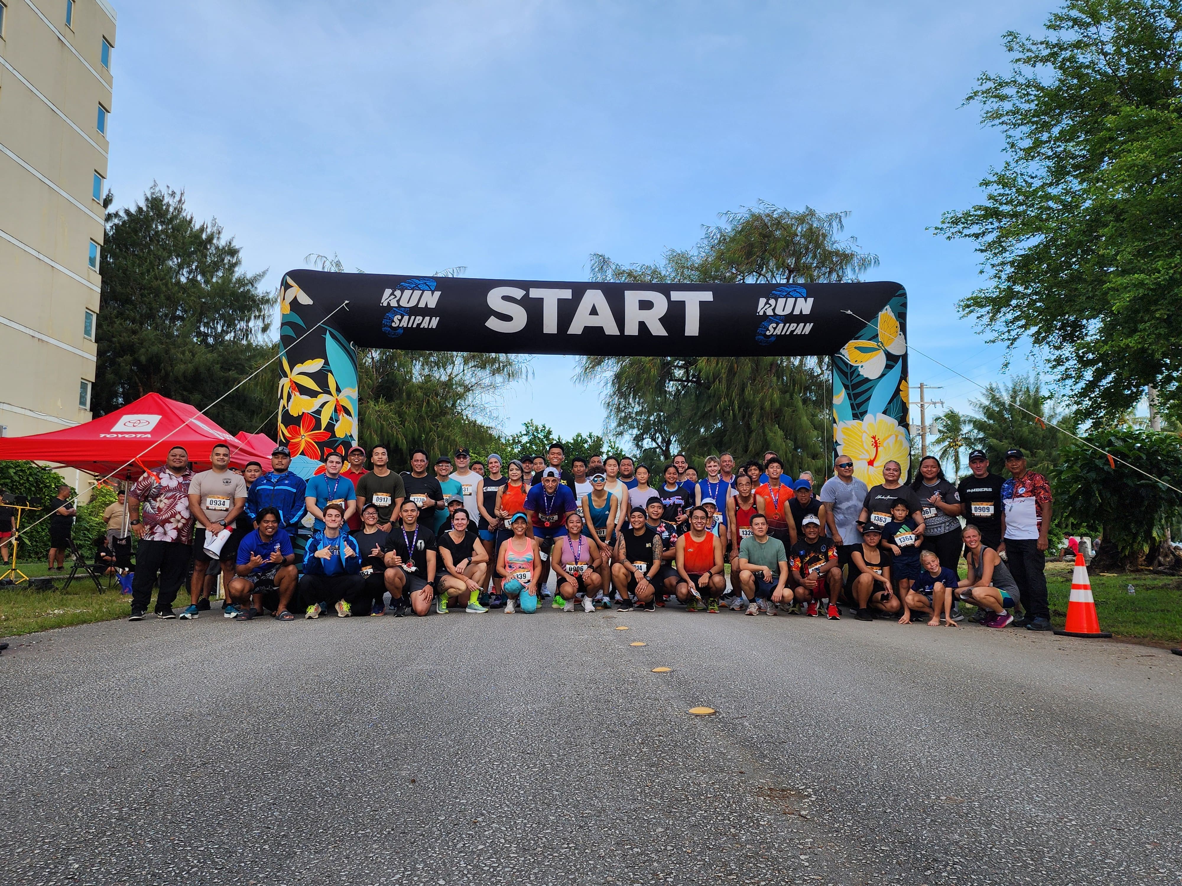 Participants pose for a group photo at the conclusion of Run Saipan’s Veterans Day 5K 2024 at Micro Beach Monday morning.