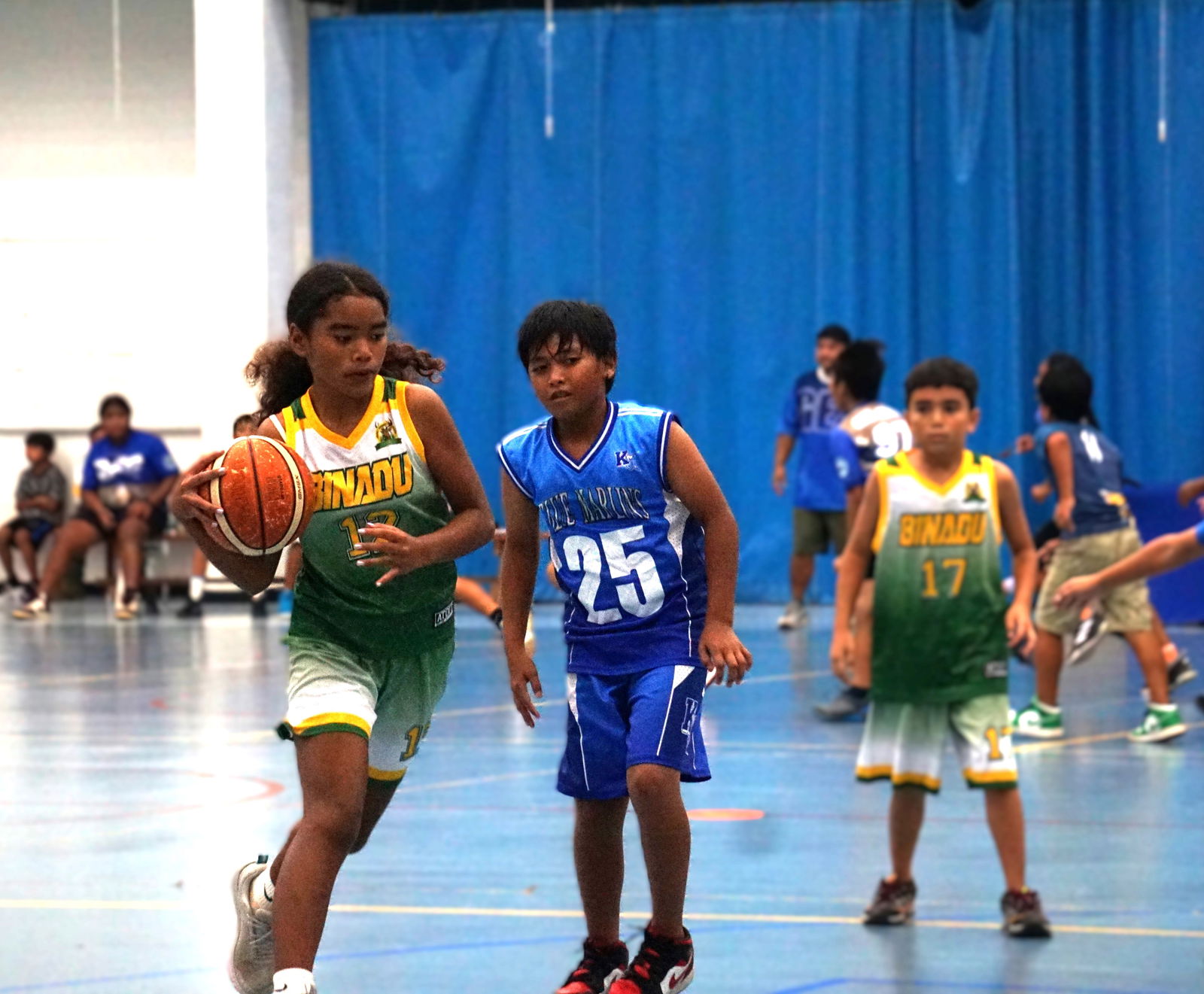 Gregorio T. Camacho Elementary School's Maleia Saures protects the ball as she drives toward the hoop during a game against Kagman Elementary School in the co-ed elementary school division of the PSS-NMIBF Interscholastic Basketball League SY4-25 at the MHS gym.