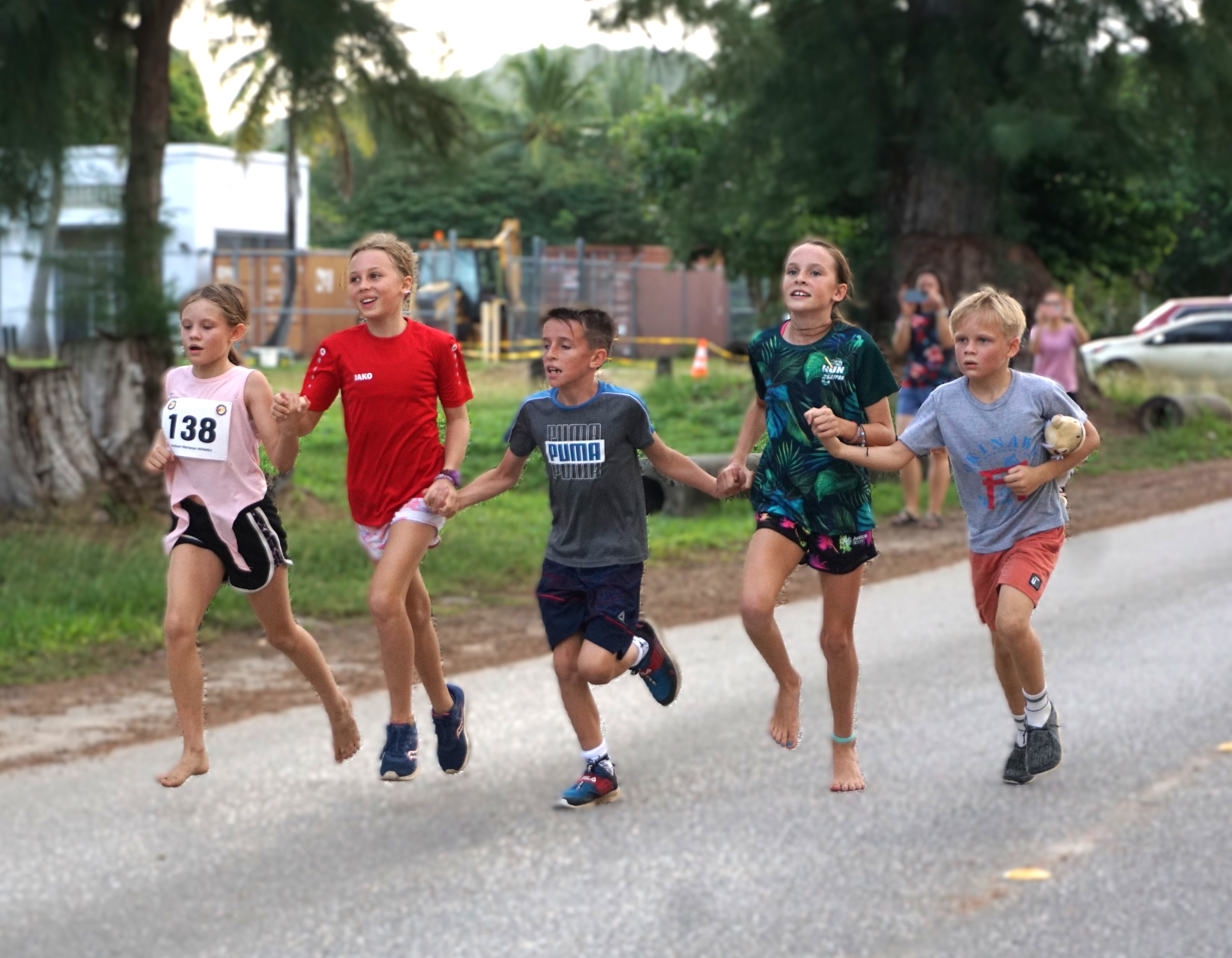 The Snow Leopards hold hands as they reach the finish line.