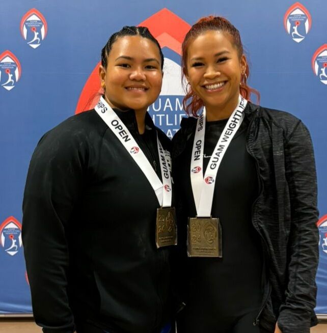 Antonette Labausa and Devine Pua pose with the gold medals they won at the 2024 Guam National Championships in Guam on Saturday.