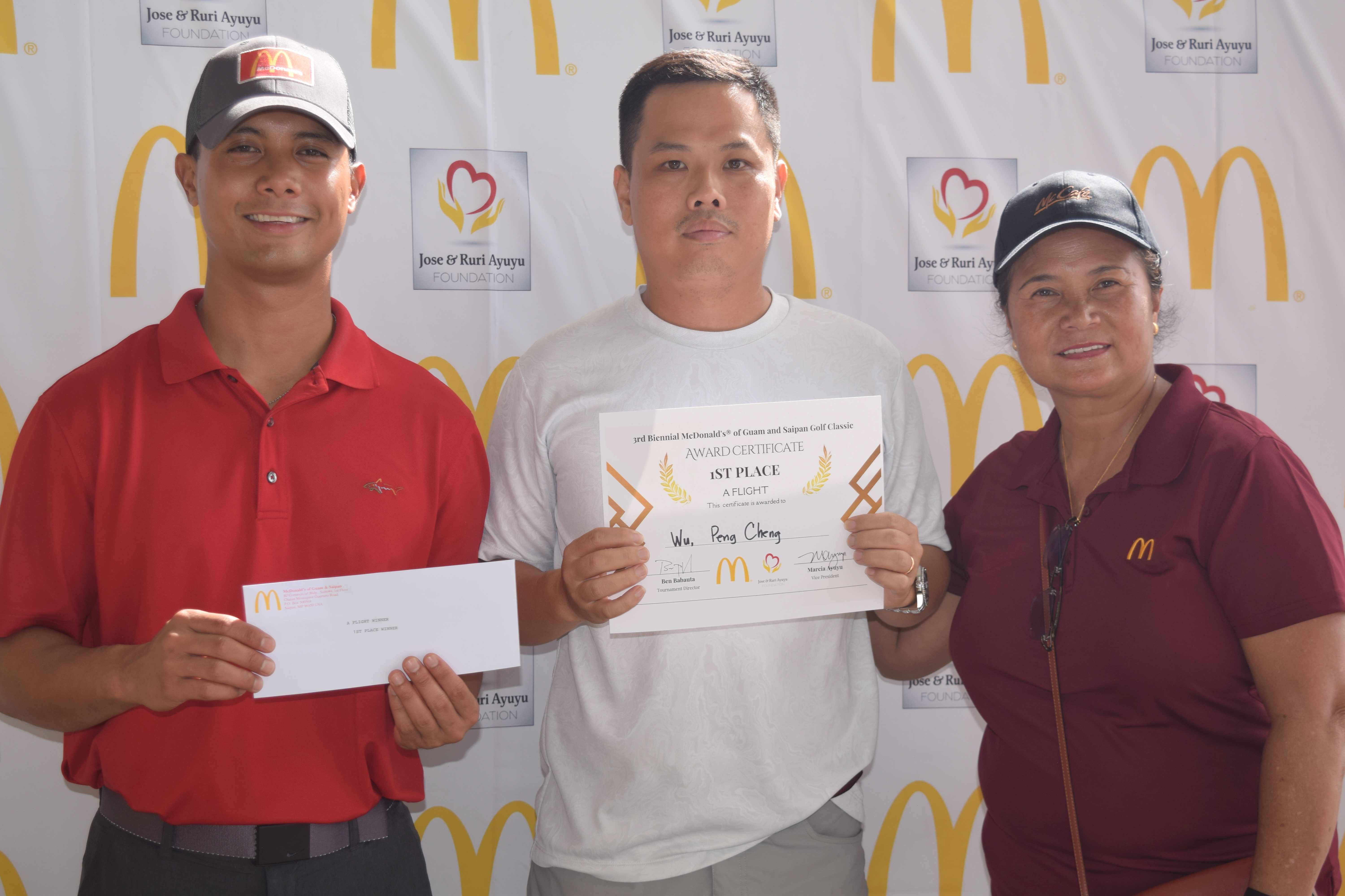 A Flight Champion Pengcheng Wu, center, receives his prize from McDonald's of Guam and Saipan Vice President Joe E. Ayuyu Jr.,  left, and owner/operator Marcia Ayuyu.