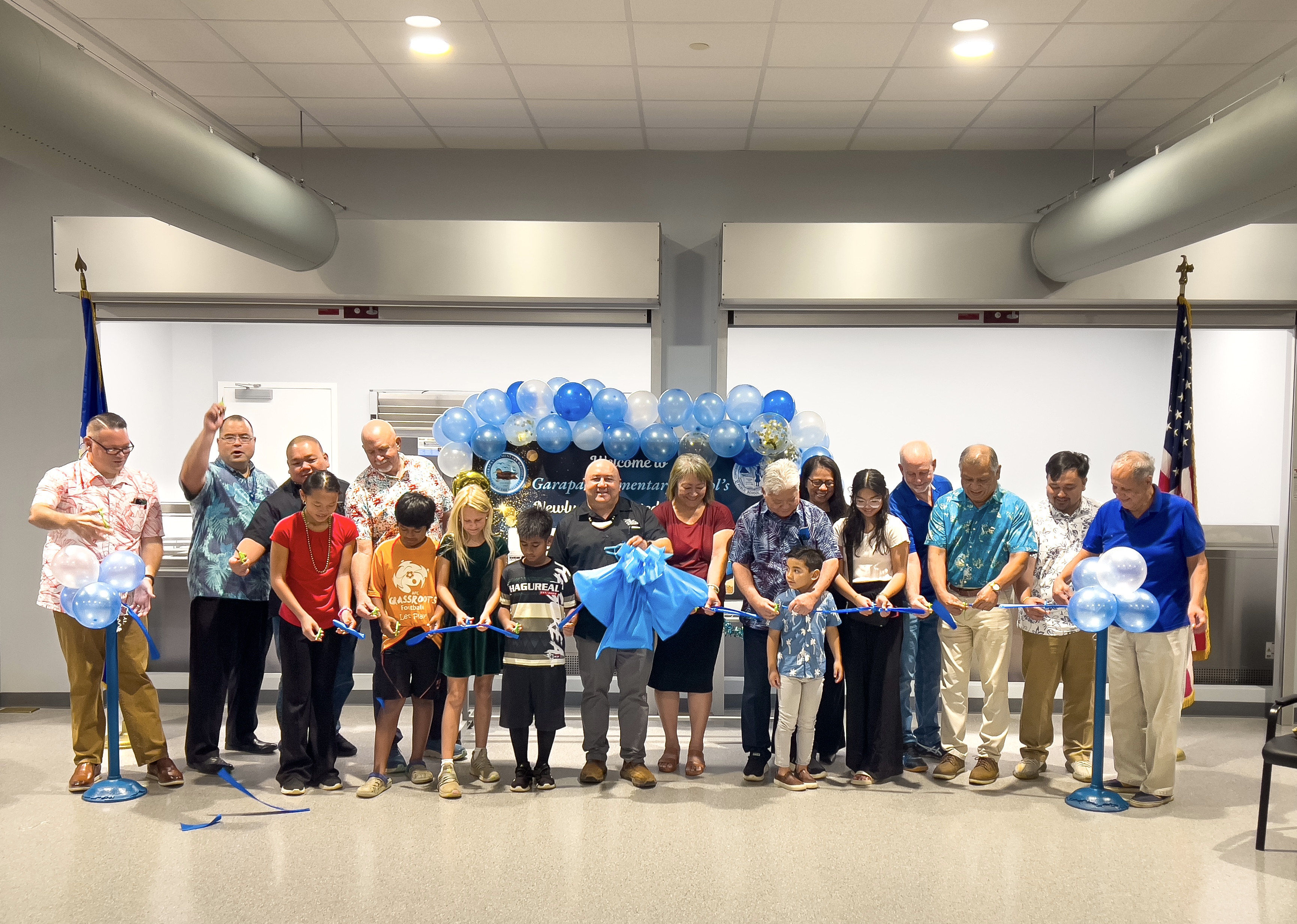 Student leaders join CNMI and education officials in cutting the ceremonial ribbon for the newly constructed Garapan Elementary School cafeteria. With the students are GES Principal Derwin Johnson, Commissioner of Education Lawrence F. Camacho, Board of Education Vice Chair Maisie B. Tenorio, Gov. Arnold I. Palacios, Senate President Edith Deleon Guerrero, House Speaker Edmund Villagomez, Associate Commissioner for Administrative Services Eric Magofna, Public School System-Child Nutrition Program Director Dale Roberts, PSS-Facilities Development and Management Director Edward Mendiola, Herman’s Modern Bakery President Herman T. Guerrero, and HBR International General Manager John Gilbert Saludez.