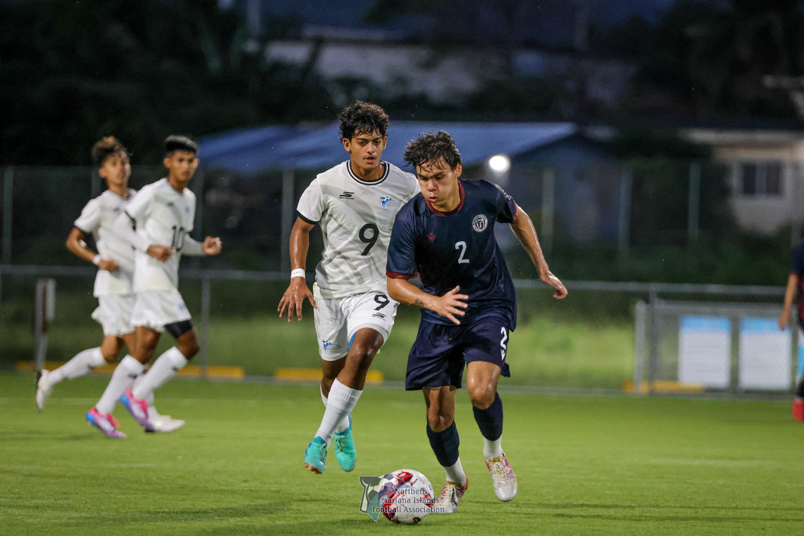 Guam’s Morgan McKenna dribbles past the NMI’s Dev Bachani during the second game of the Marianas Friendlies at the NMI Soccer Training Center in Koblerville on Sunday.