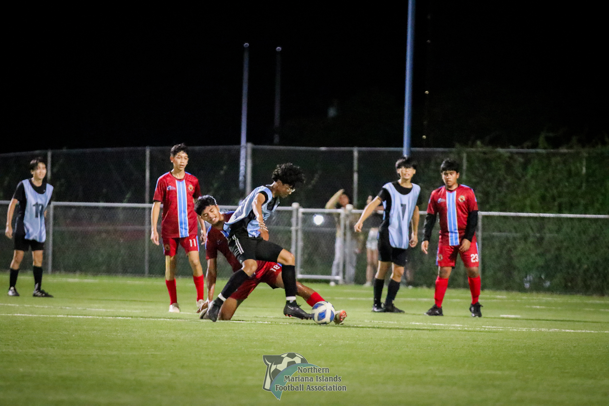 Kagman High School's Nolan Ngewakl loses his balance while battling for possession during a game in the boys high school division of the PSS-NMIFA Interscholastic Soccer League SY24-25 at the NMI Soccer Training Center in Koblerville.NMIFA photo