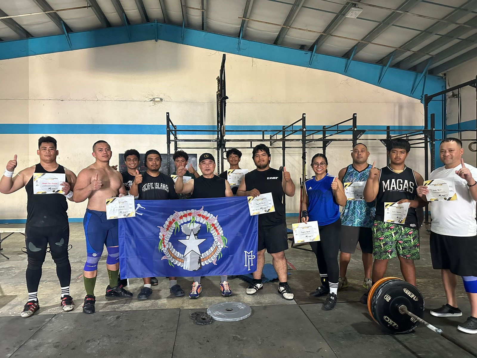 Participants pose with their certificates of completion at the conclusion of the Olympic weightlifting program conducted by Coach Jianping Ma in collaboration with local weightlifter Angel San Nicolas at the GetFitCNMI gym over the weekend. 