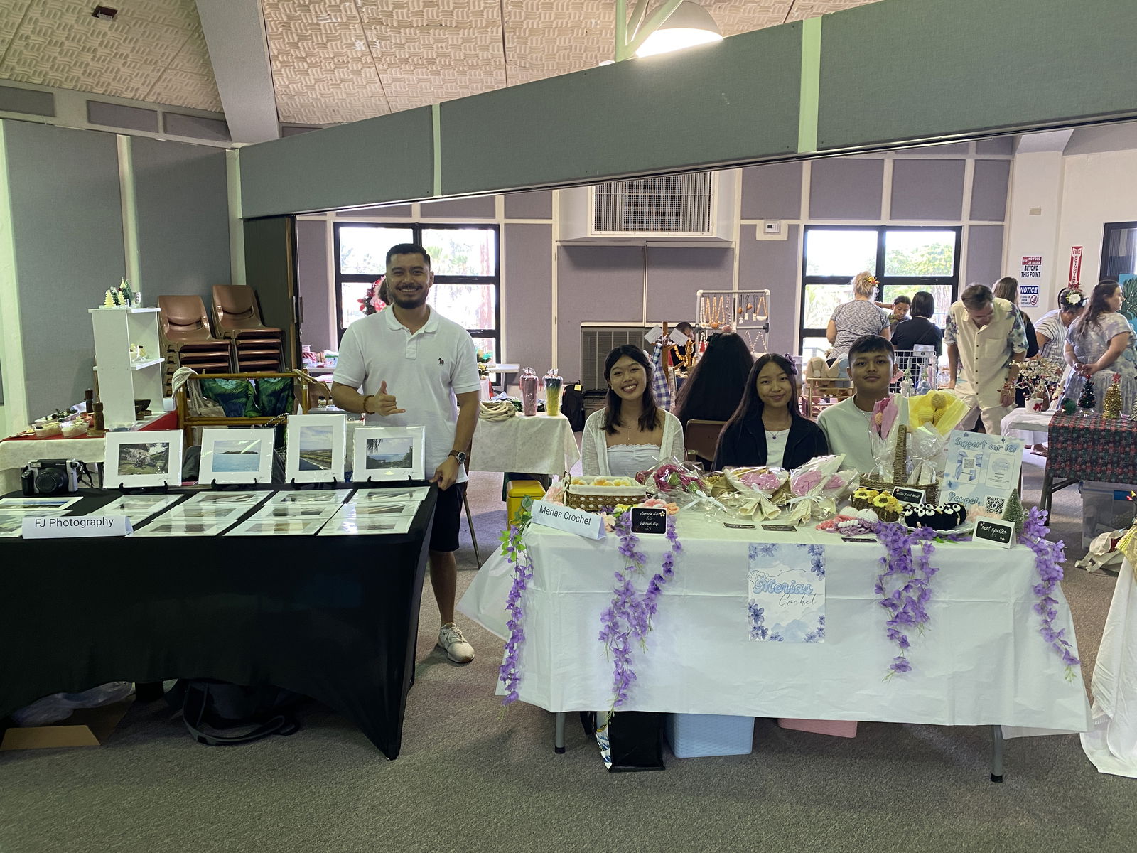 Vendors pose for a picture during the 4th Annual Christmas Art Bazaar at the multi-purpose center on Friday.