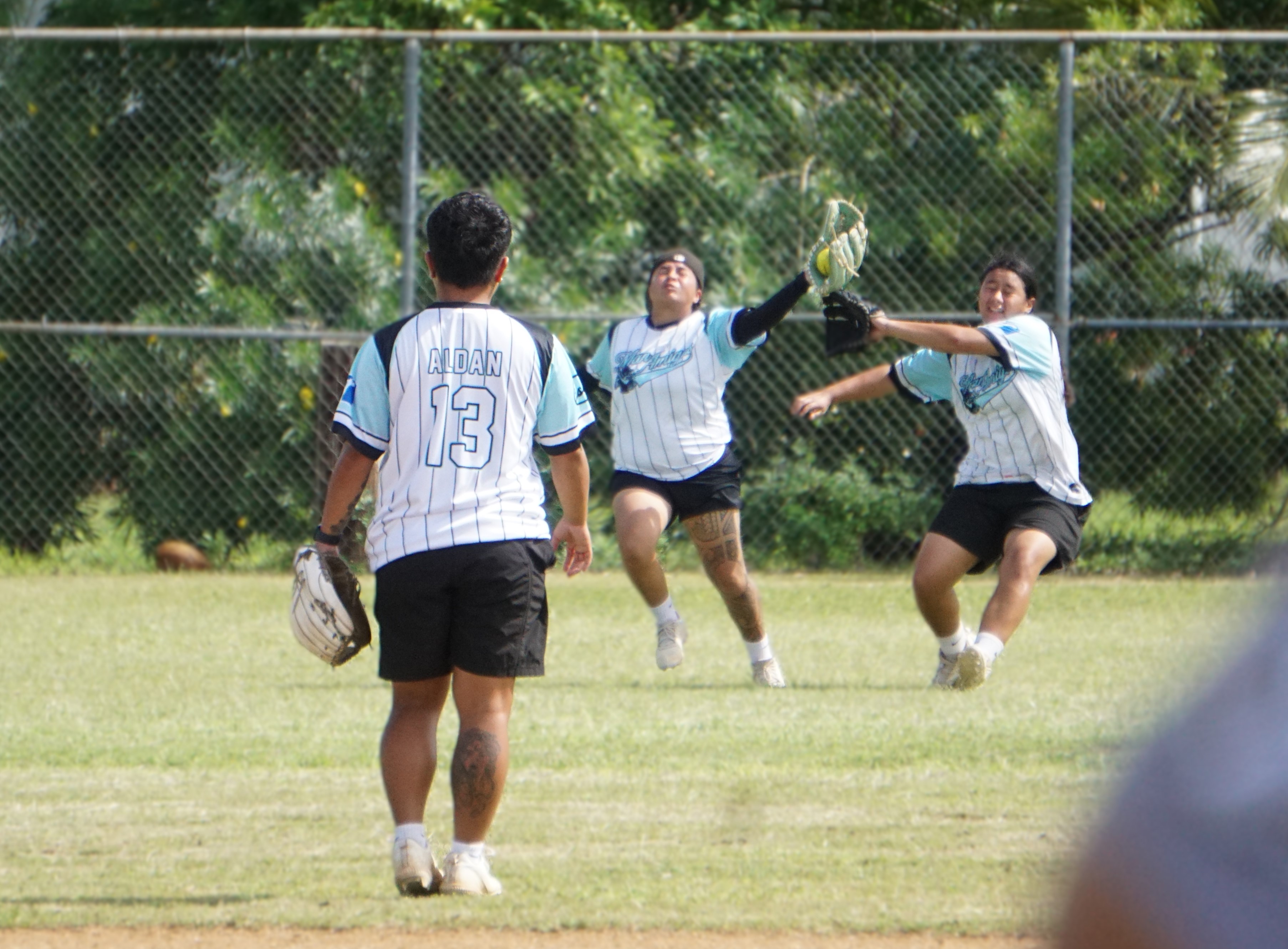The Man Amigas’ Keo Rios catches the flyout against the Batties at the Miguel "Tan Ge" Pangelinan softball field on Saturday.
