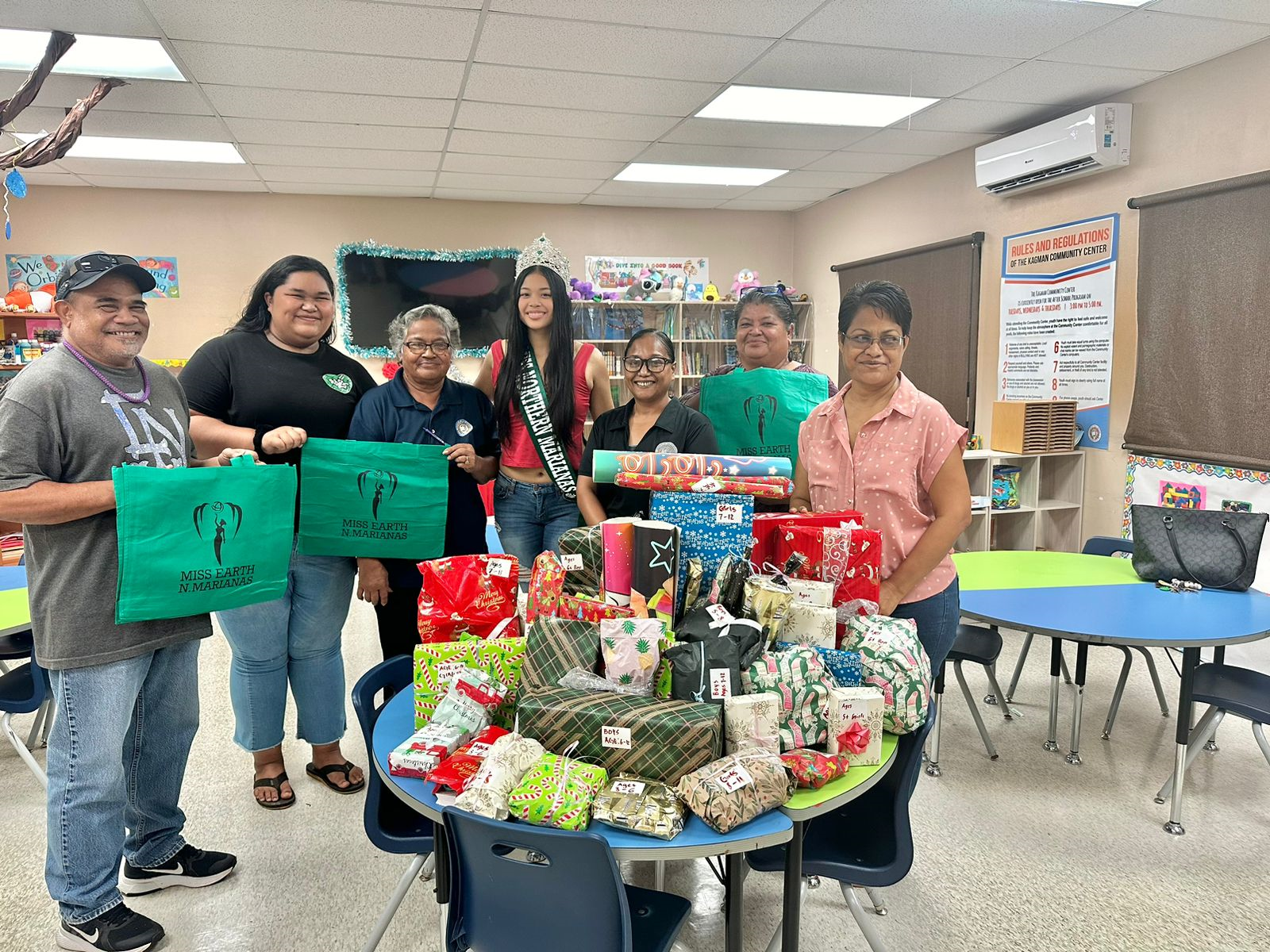 2024 Miss Earth Northern Marianas Heavenly Pangelinan and Division of Youth Services staff pose with toys at the Kagman Community Center.