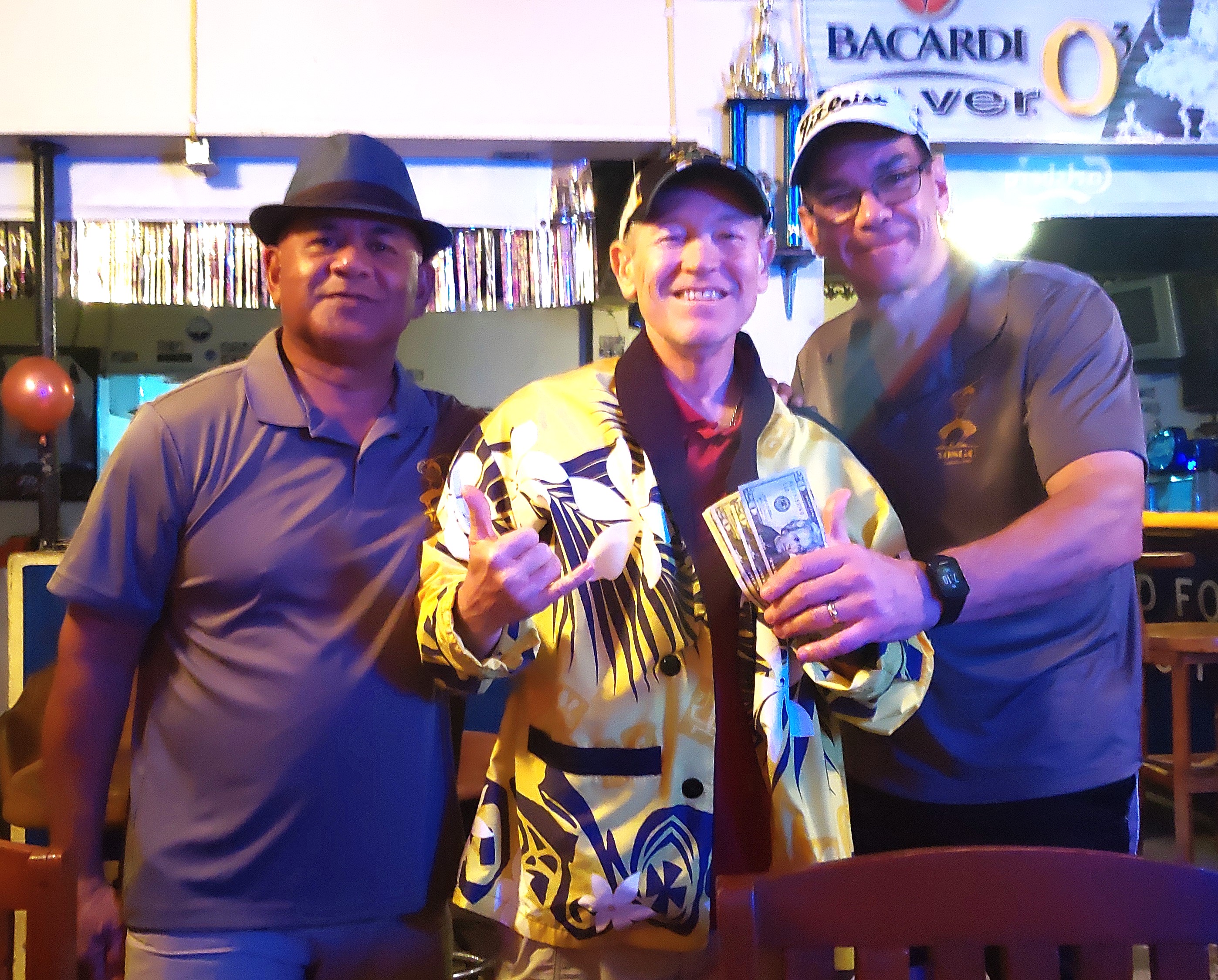 Timothy “Tex” Brasuell receives the prize money from 2016 champion Mike “26” Deary and  2023 champ Paki Maui.