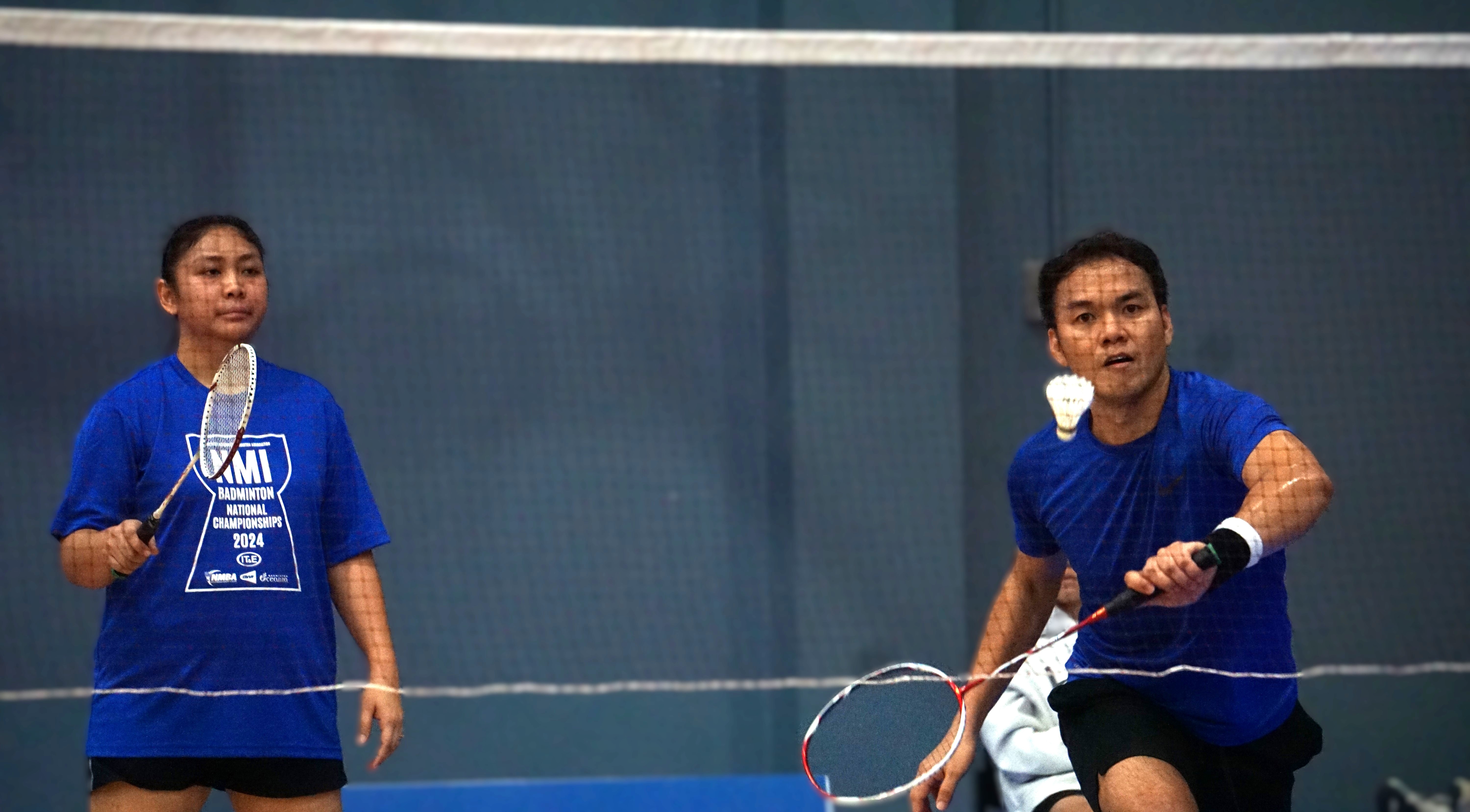 Lance Gallardo reaches out for the backhand return alongside teammate Trizian Canoza during the mixed doubles championship match in the open division of the NMI Badminton National Championships 2024 at the Ada gym on Saturday. 