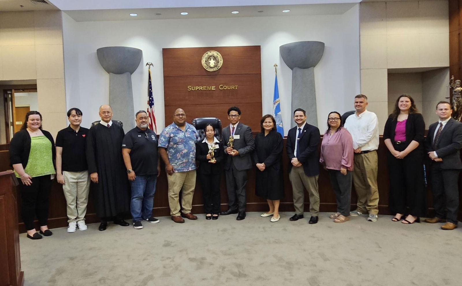 Runners up Carlyn Dela Cruz and Christopher Dela Cruz of Mount Carmel School, center, with judiciary and MCS officials as well as court personnel.