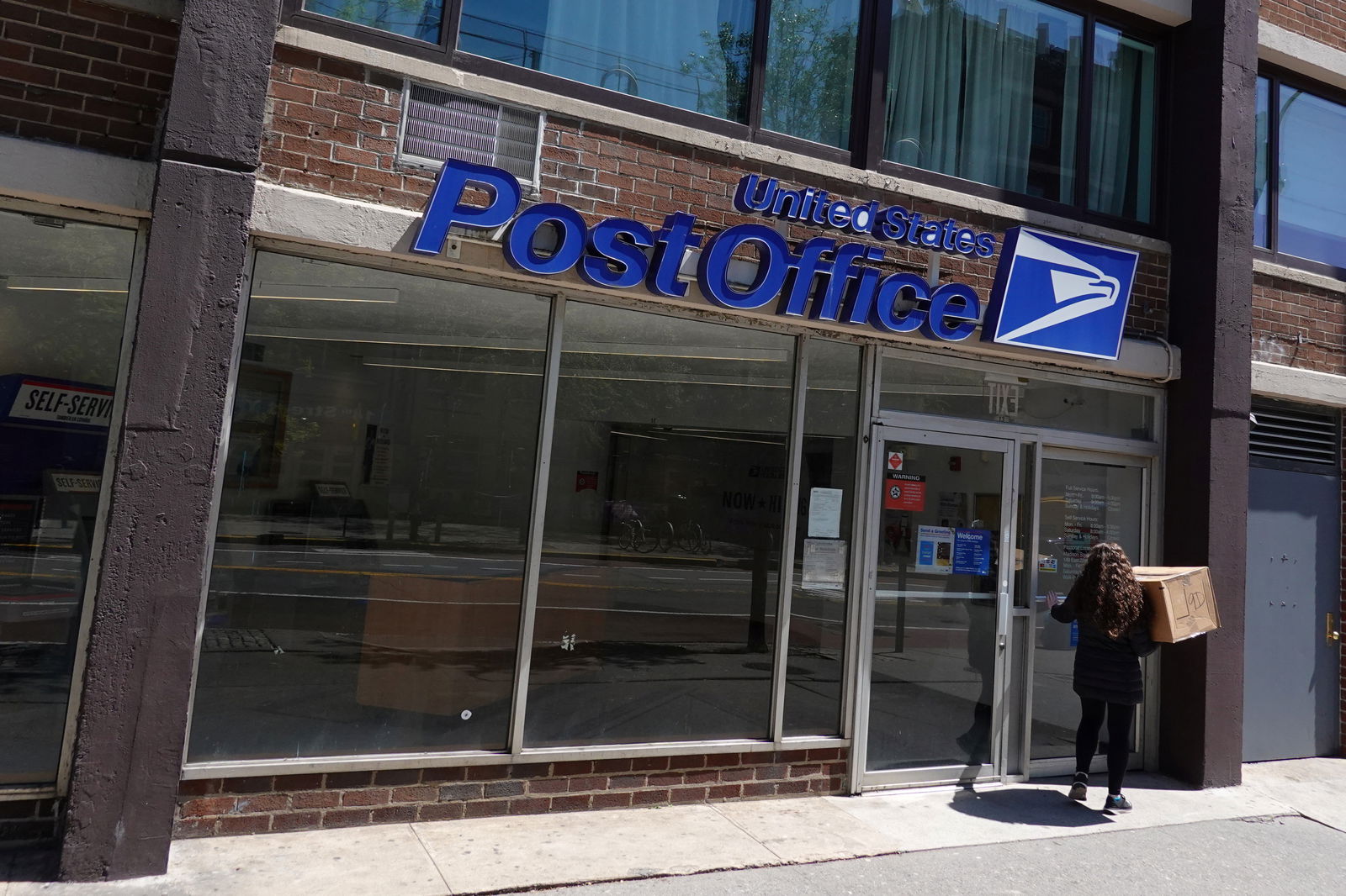 A person enters a United States Postal Service Post Office in Manhattan, New York City, May 9, 2022.