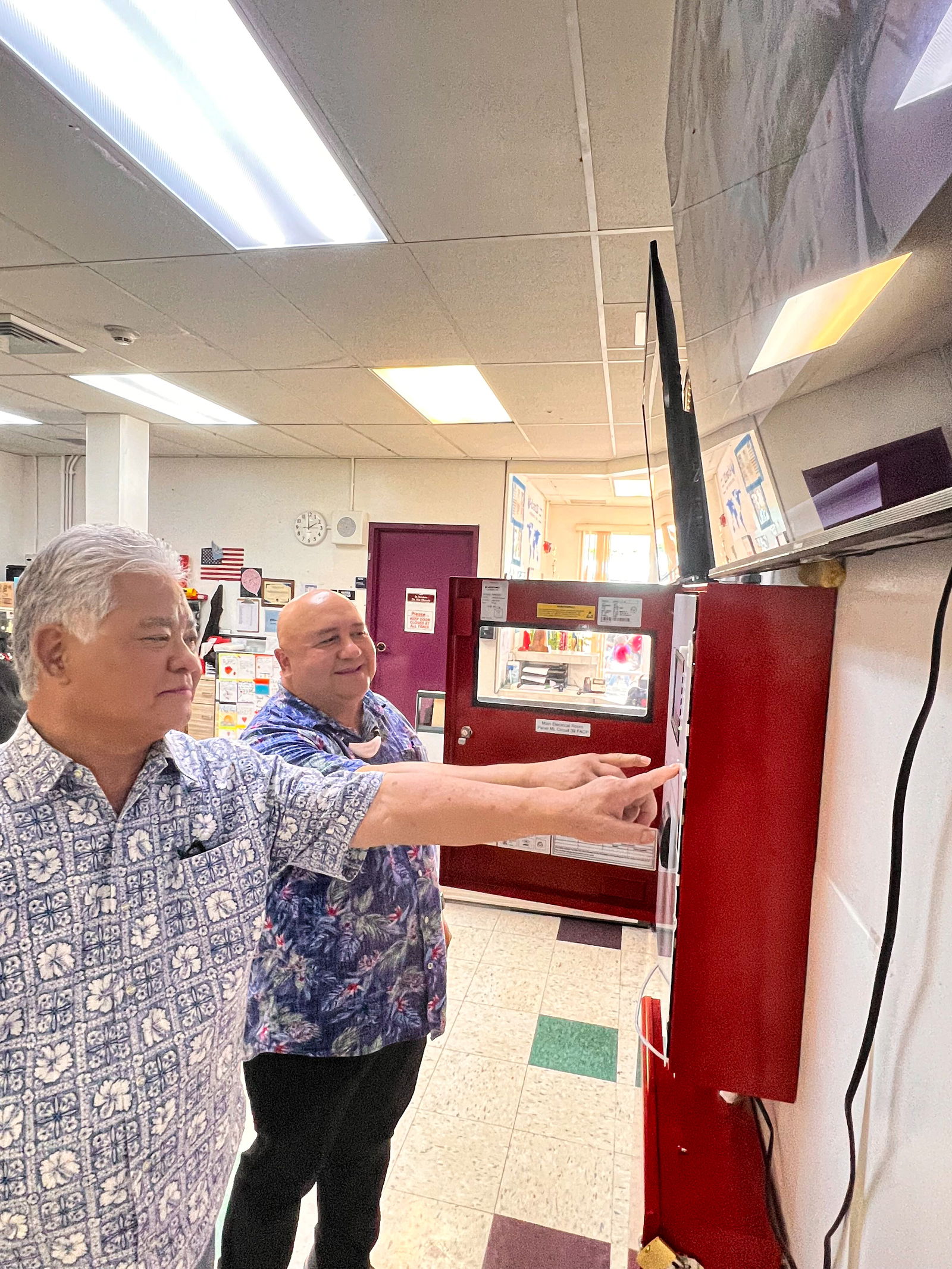 Gov. Arnold I. Palacios and Commissioner of Education Dr. Lawrence F. Camacho inspect the new state-of-the-art fire alarm, bell, and intercom system of the Public School System.