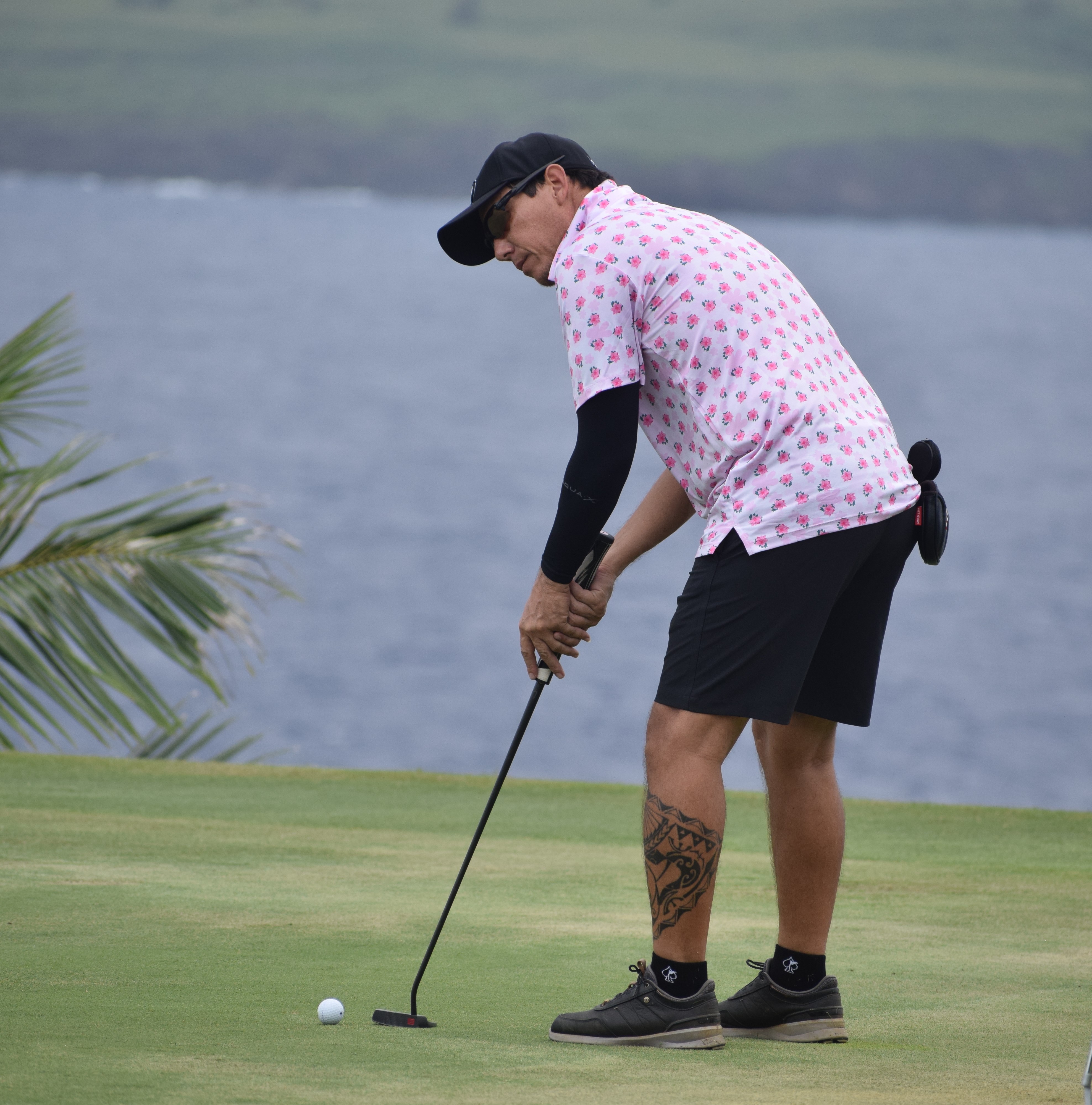 Peter Tenorio putts on Hole No. 15 with LaoLao Bay as a backdrop during the 3rd Biennial McDonald's of Guam and Saipan Golf Classic on Saturday at LaoLao Bay Golf & Resort's east course.