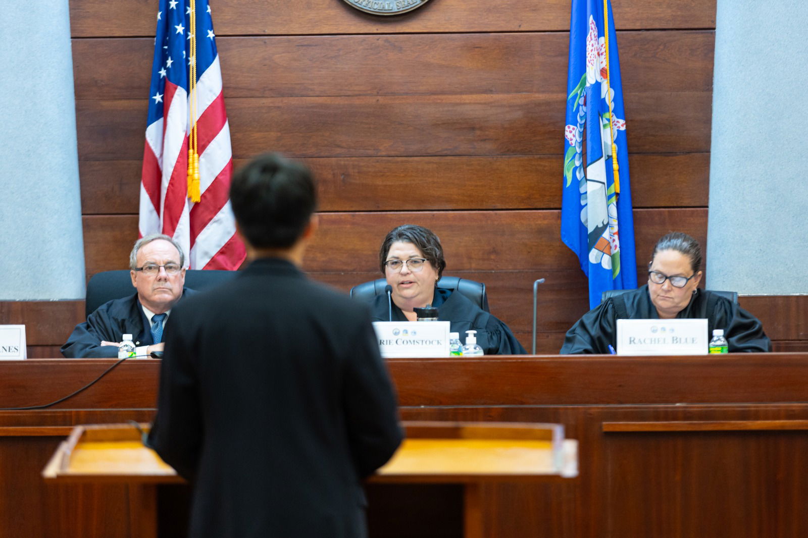 A student advocate argues before volunteer justices David Banes, Karie Comstock, and Rachel Blue.