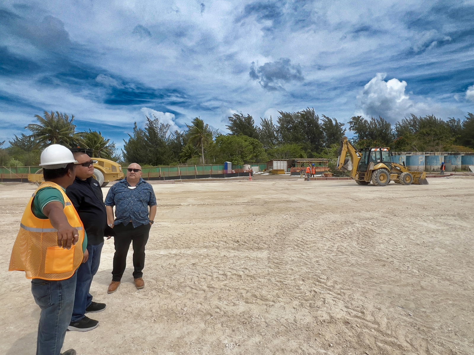 Commissioner of Education Dr. Lawrence F. Camacho, accompanied by Associate Commissioner for Administrative Services Eric Magofna, inspects the installation of prefabricated modular classrooms at Hopwood Middle School.