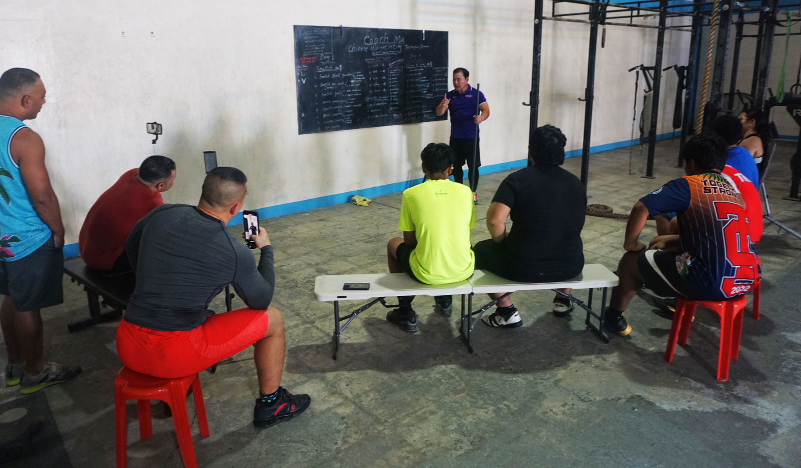 Coach Jianping Ma breaks down the aspects of Chinese weightlifting technique during a seminar held over the weekend at the GetFitCNMI gym.