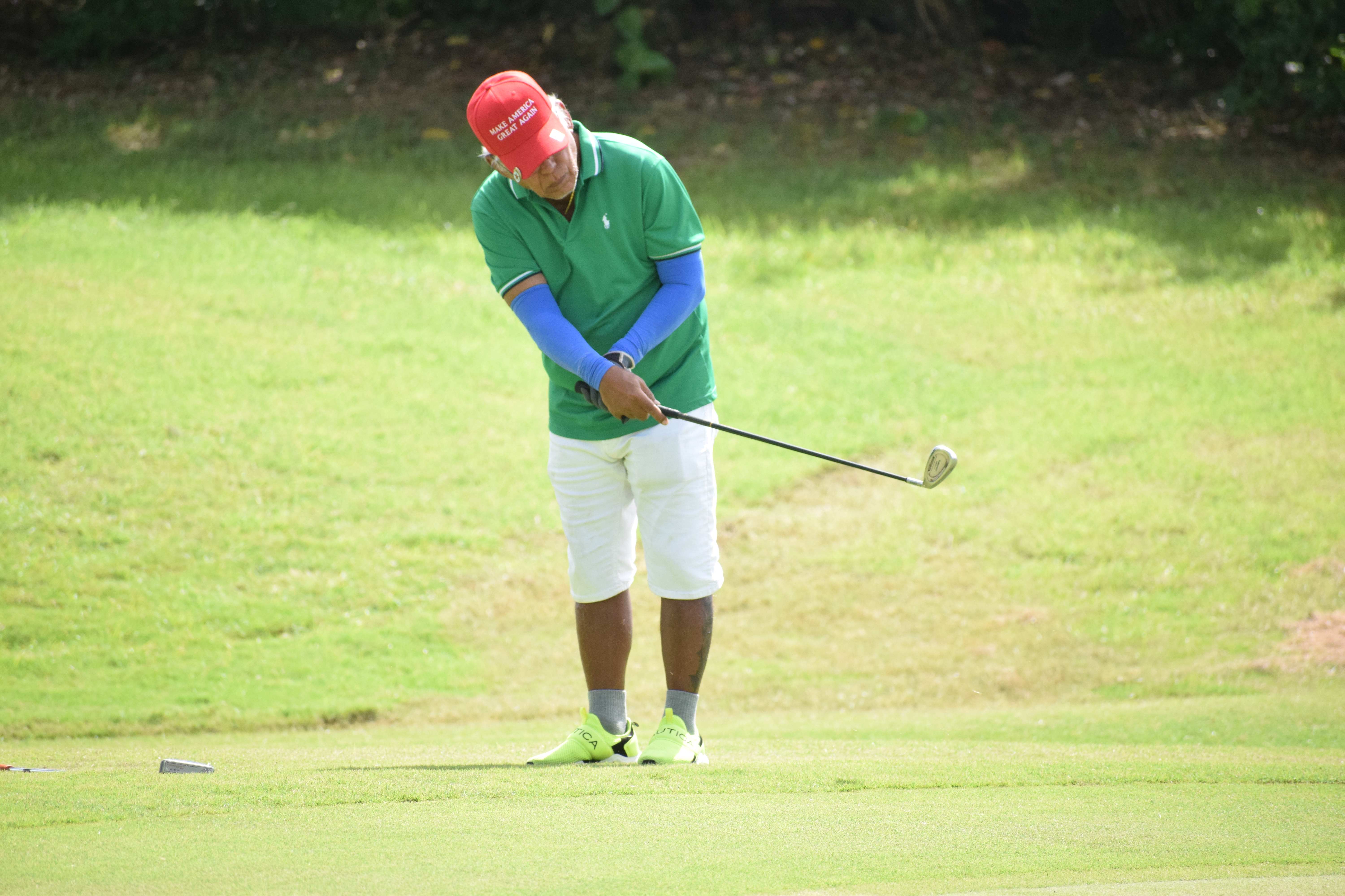 C Flight champion Pete P. Reyes chips onto the green of Hole No. 15.