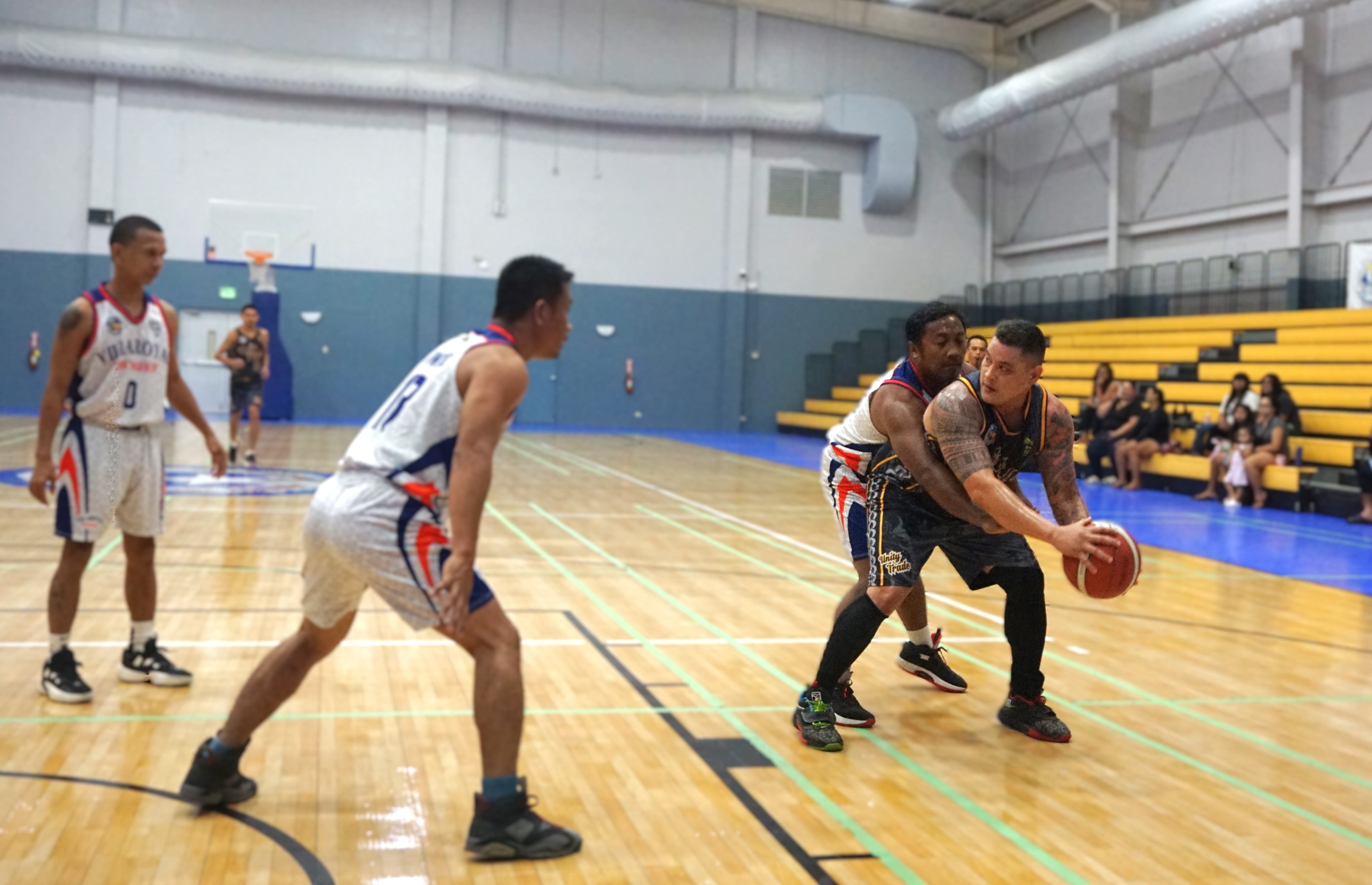 Unity Trade's Juan Camacho protects the ball as three defenders close in during a game against Villaroyal Pawnshop in the open division of the 2nd Saipan Magalahi Eagles Club – Saipan MagaHaga Lady Eagles Group Basketball Tournament at the Ada gym on Saturday. 