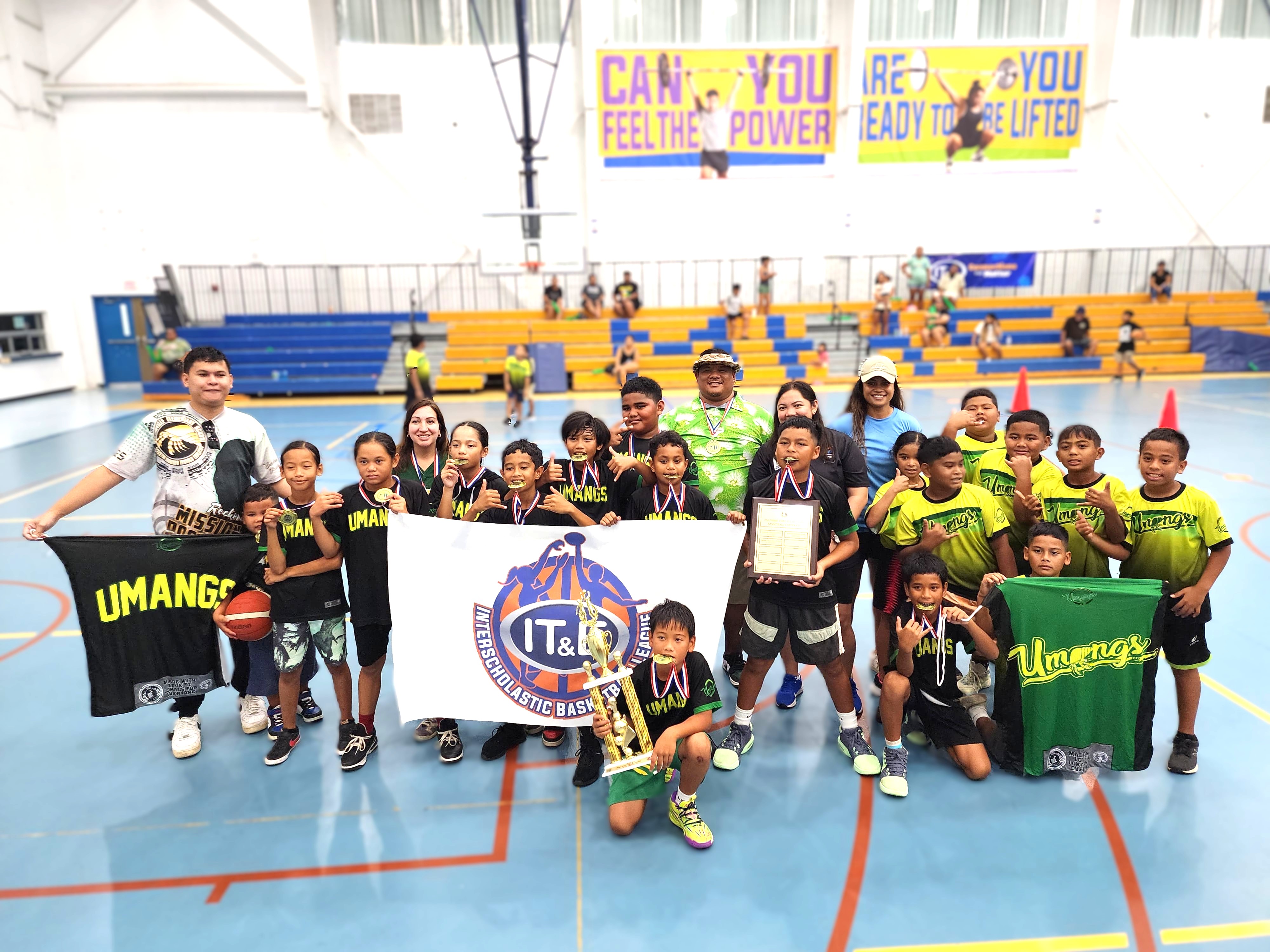 Koblerville Elementary School 1 players pose with the championship title in the elementary school division of the PSS-NMIBF Interscholastic Basketball League SY24-25 at the Marianas High School gym.  