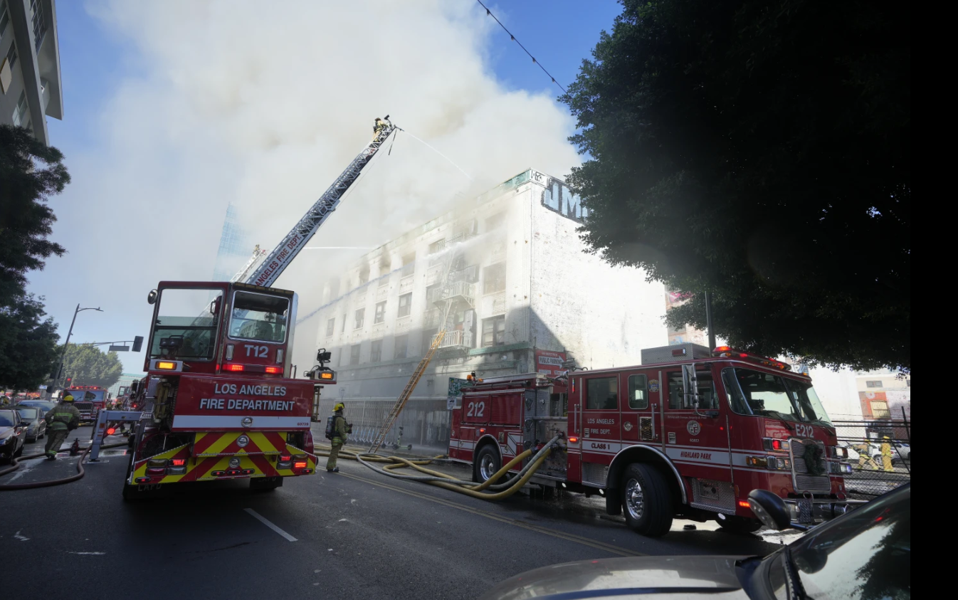 Fire crews battle a building fire on the 1200 block of South Hope Street, Thursday, Dec. 26, 2024 in Los Angeles.