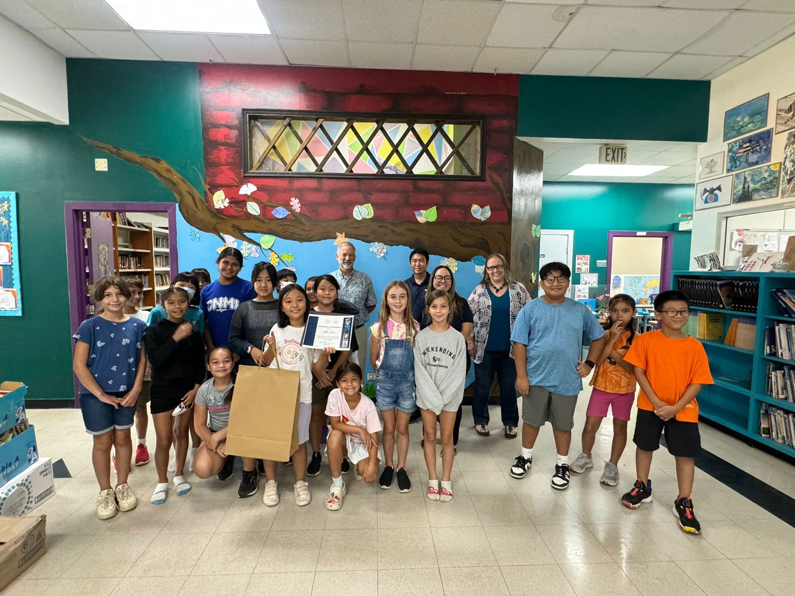 Stella Park with her Saipan International School classmates and headmaster Dr. Ron Snyder, Pacifica staff Tyler Yoshimoto and Dionne Camacho.