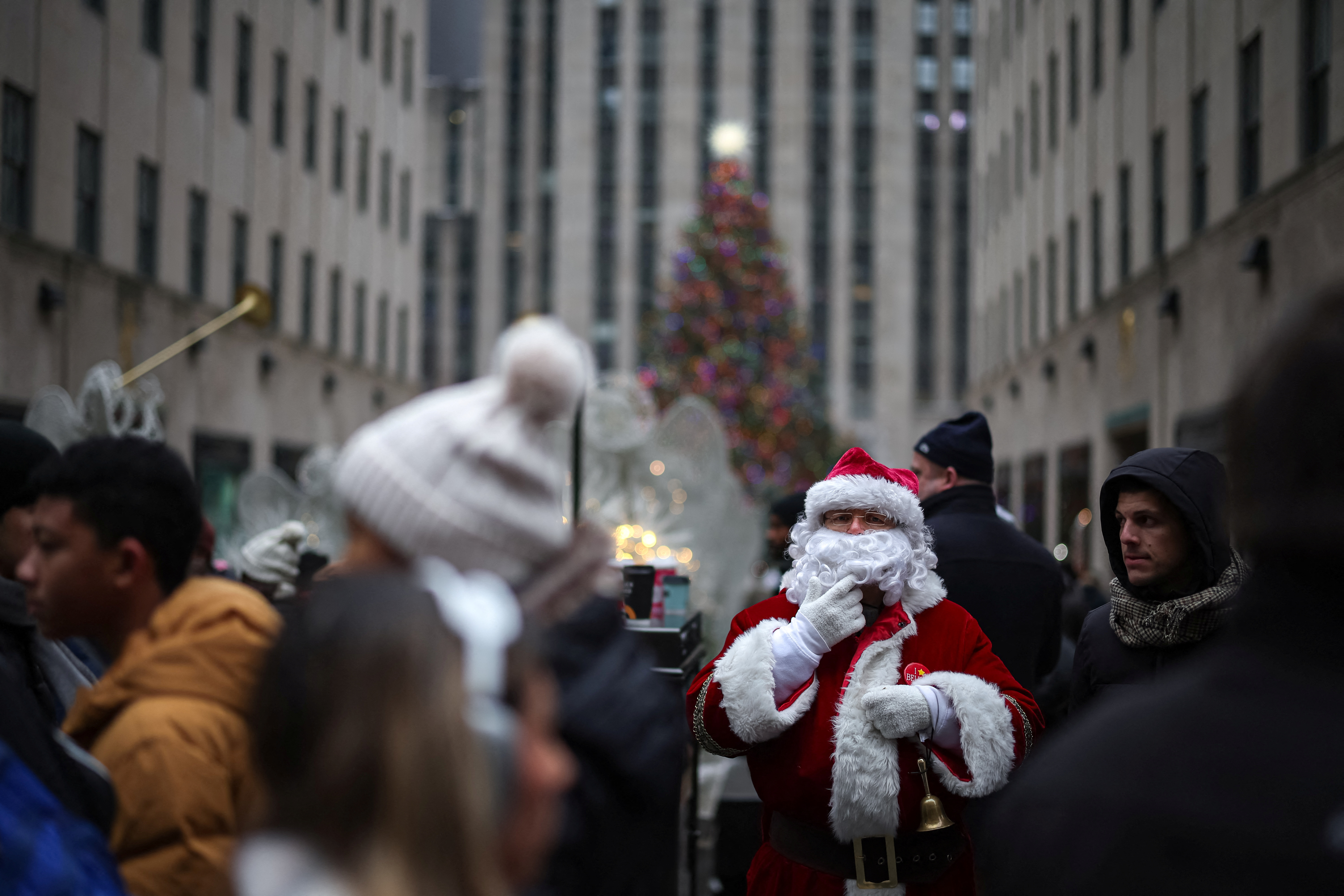A man dressed as Santa stands in front of the Rockefeller Center Christmas Tree in Manhattan in New York City, Dec. 24, 2024.