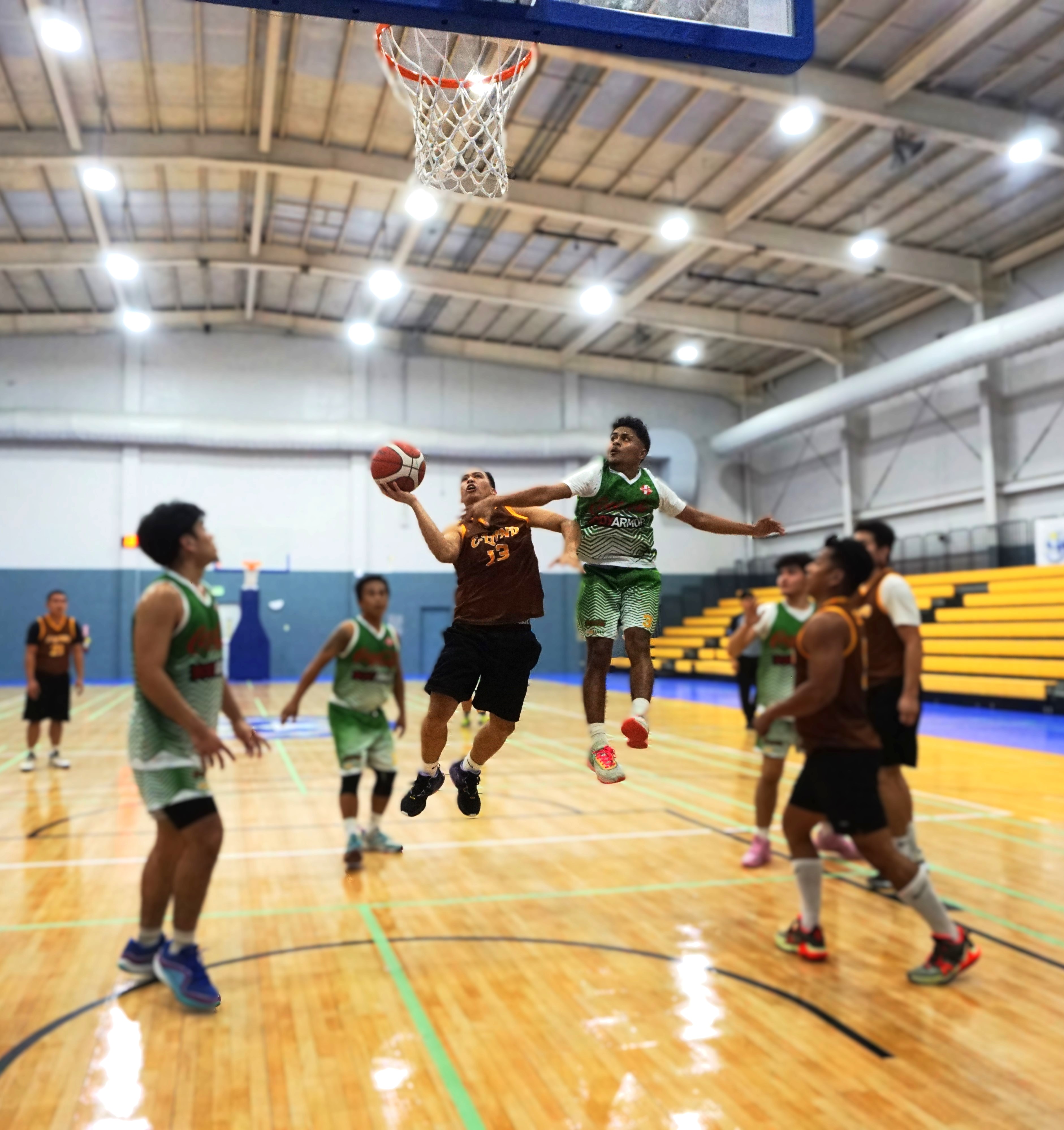 E-Land's Jonathan Gunnacao gets fouled as he goes up for the layup during a game against Coca Cola in the 2024 R&J Wine and Liquor Inter-Government/Business League at the Ada gym on Tuesday. 