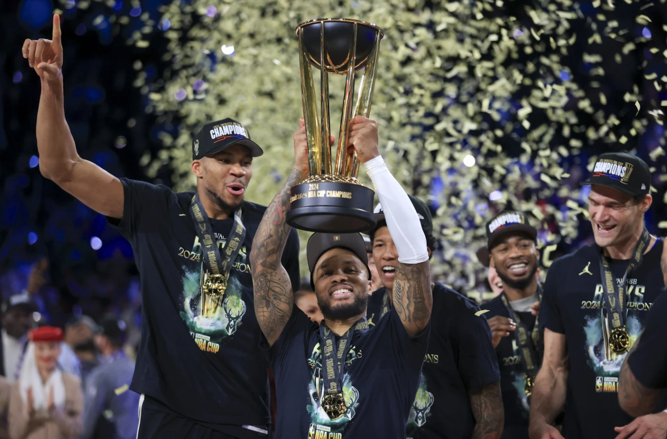 Milwaukee Bucks guard Damian Lillard lifts up the NBA Cup while forward Giannis Antetokounmpo, left, and center Brook Lopez, right, celebrate after their team’s victory in the championship game of the NBA Cup tournament against the Oklahoma City Thunder, Tuesday, Dec. 17, 2024 in Las Vegas.