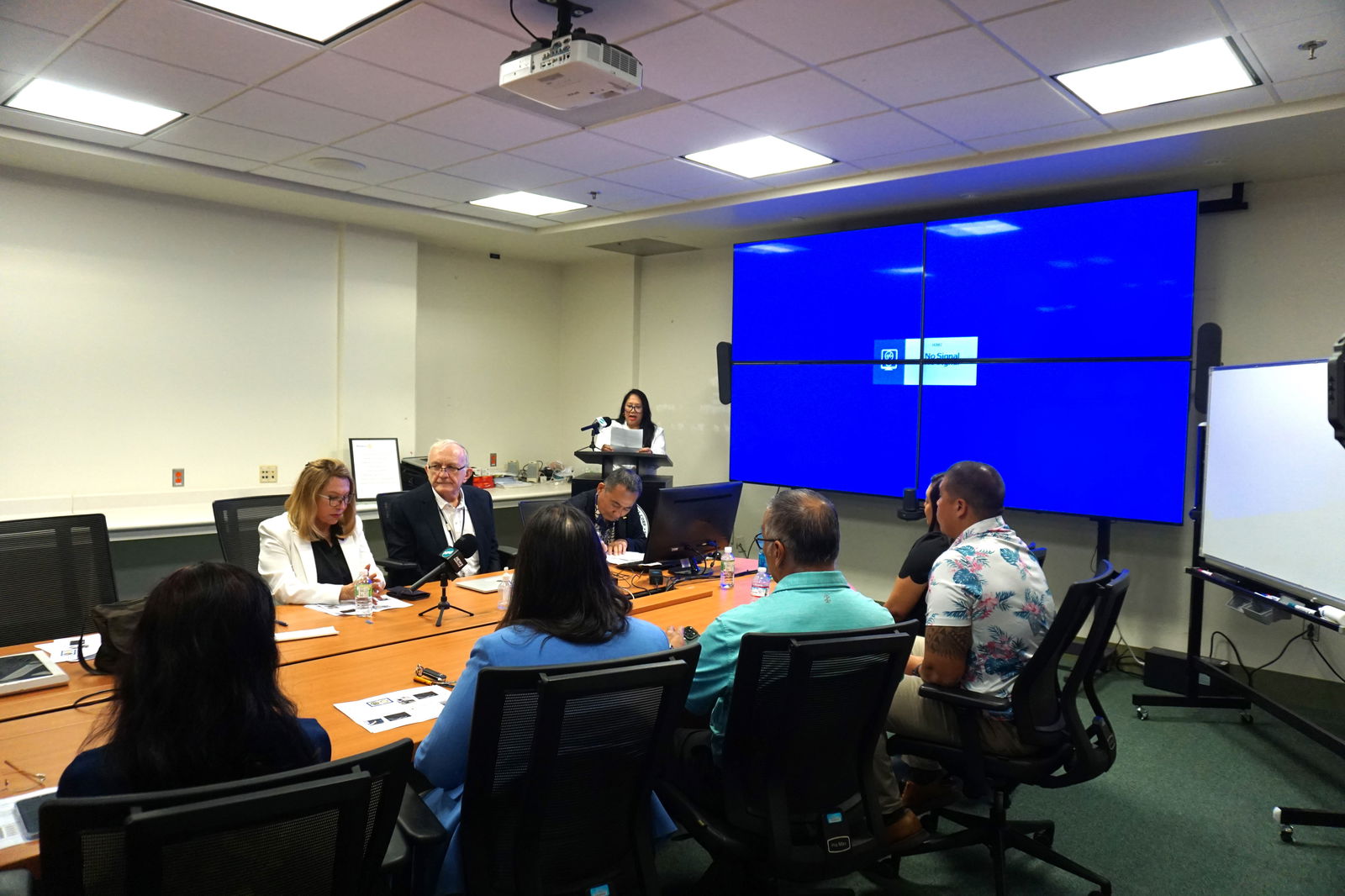 Saipan Rotary Club President Joann Aquino delivers her remarks. Also photographed, front row, second from left is Dr. Peter Gregor.