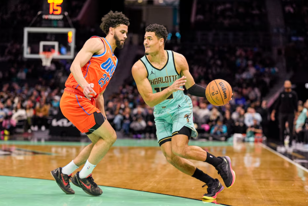 Charlotte Hornets guard Josh Green (10) drives to the basket against Oklahoma City Thunder guard Ajay Mitchell (25) during the first quarter at Spectrum Center in Charlotte, North Carolina, Dec, 28, 2024.