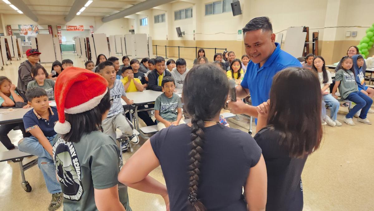 Students at Koblerville Elementary School work together to answer questions about tourism posed by Marianas Visitors Authority Community Projects Coordinator Jack Aranda.