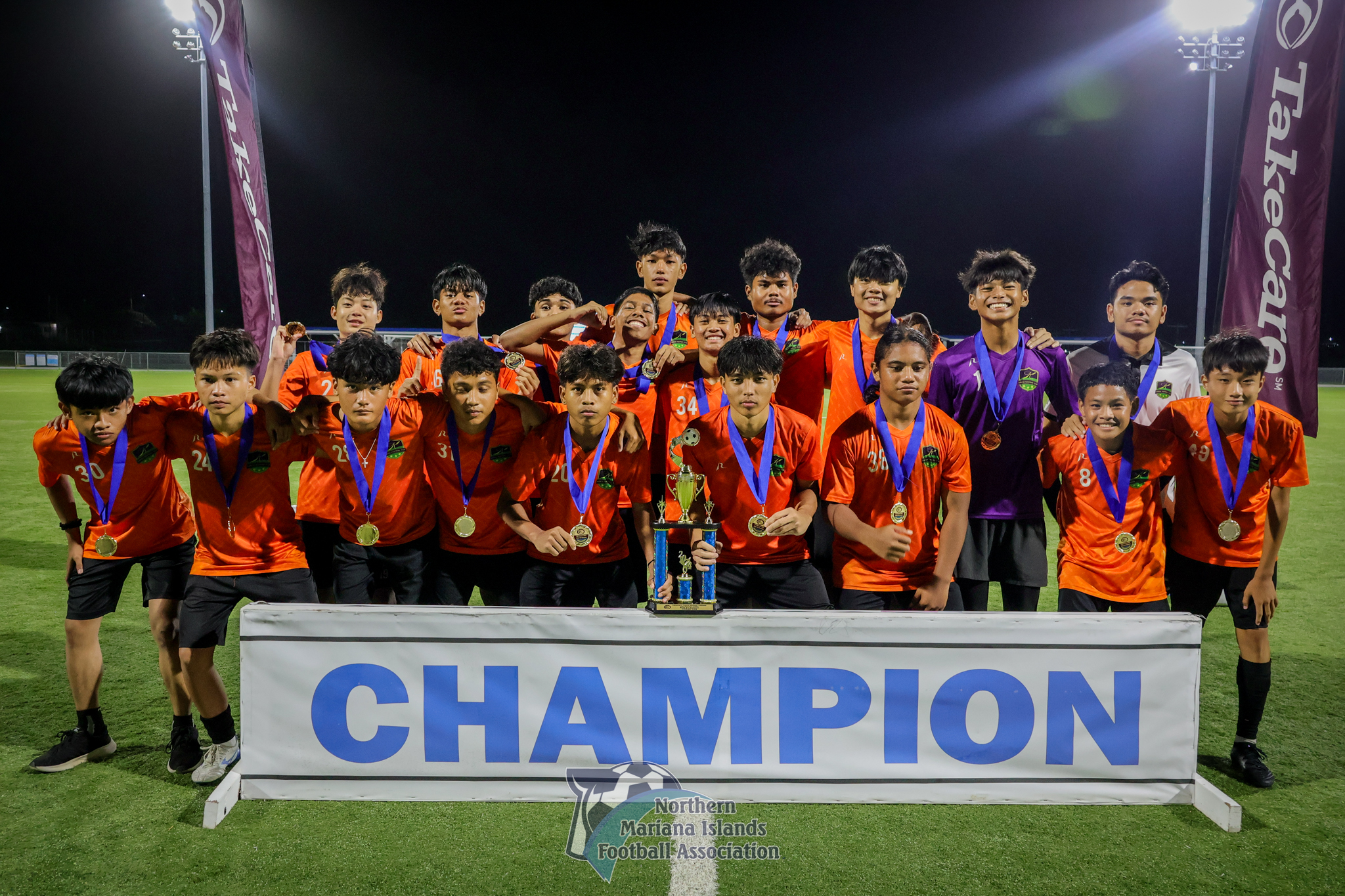 Kanoa Football Club players pose with the U17 boys division championship trophy after defeating MP United Football Club, 2-1, in the title match of the TakeCare Youth Soccer League Fall 2024 at the NMI Soccer Training Center in Koblerville on Saturday. 